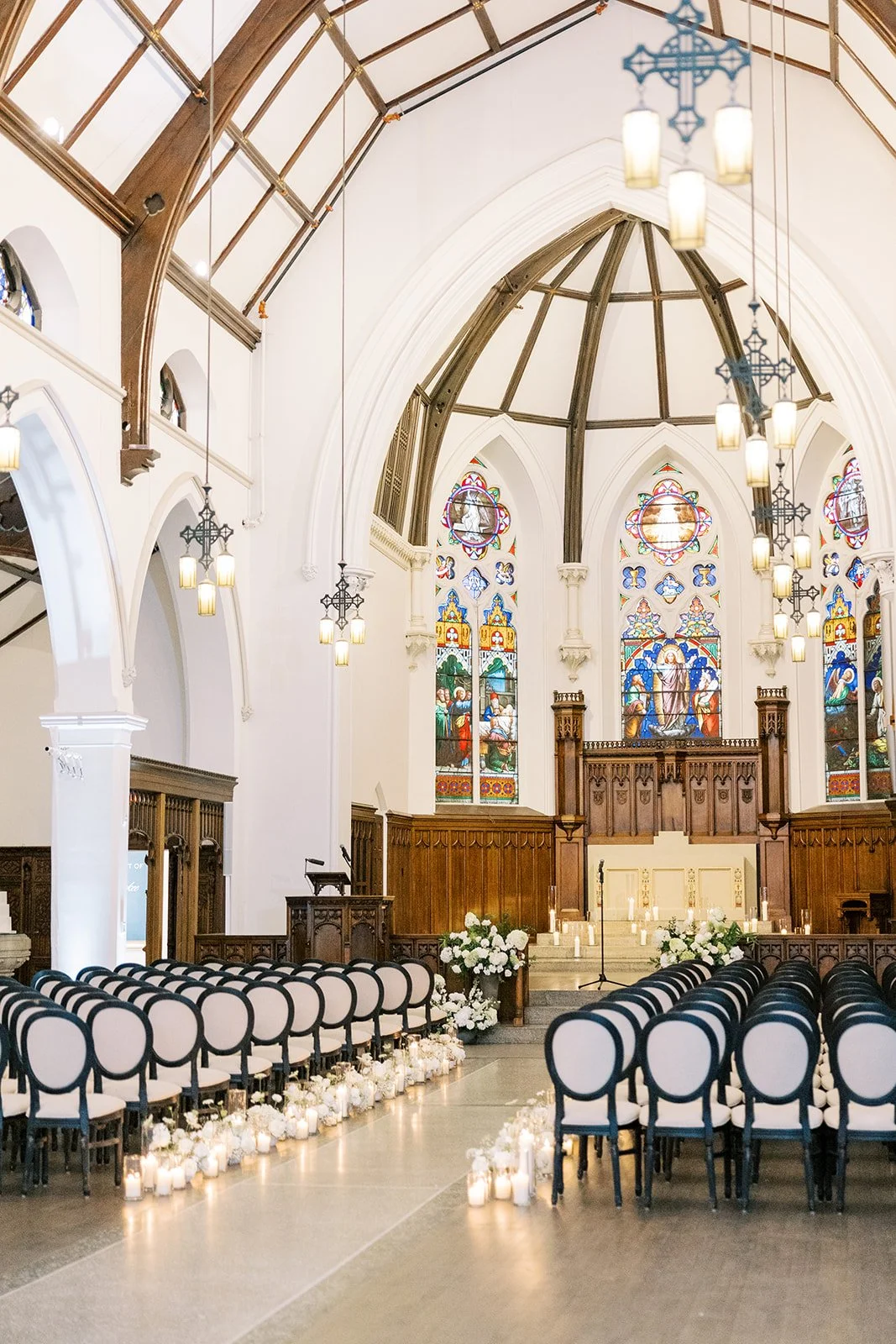 Historic wedding ceremony space inside The Abbey featuring a grand aisle and original architectural details.