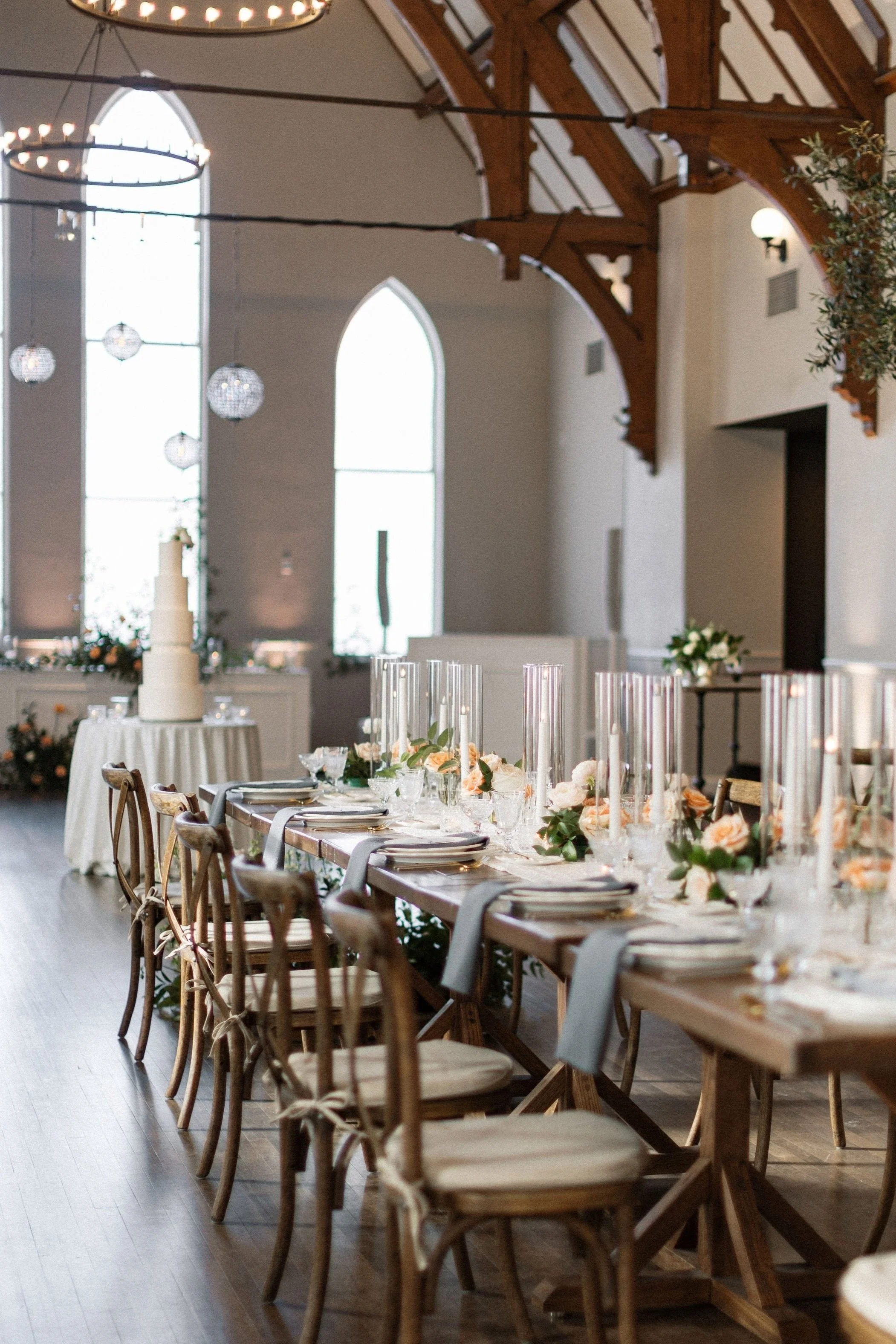 Wedding reception setup inside The Hyde featuring vaulted ceilings, expansive windows, and natural light.