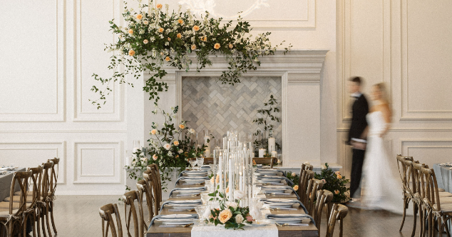 Newlywed couple walking past the fireplace during a wedding reception at The Hyde.