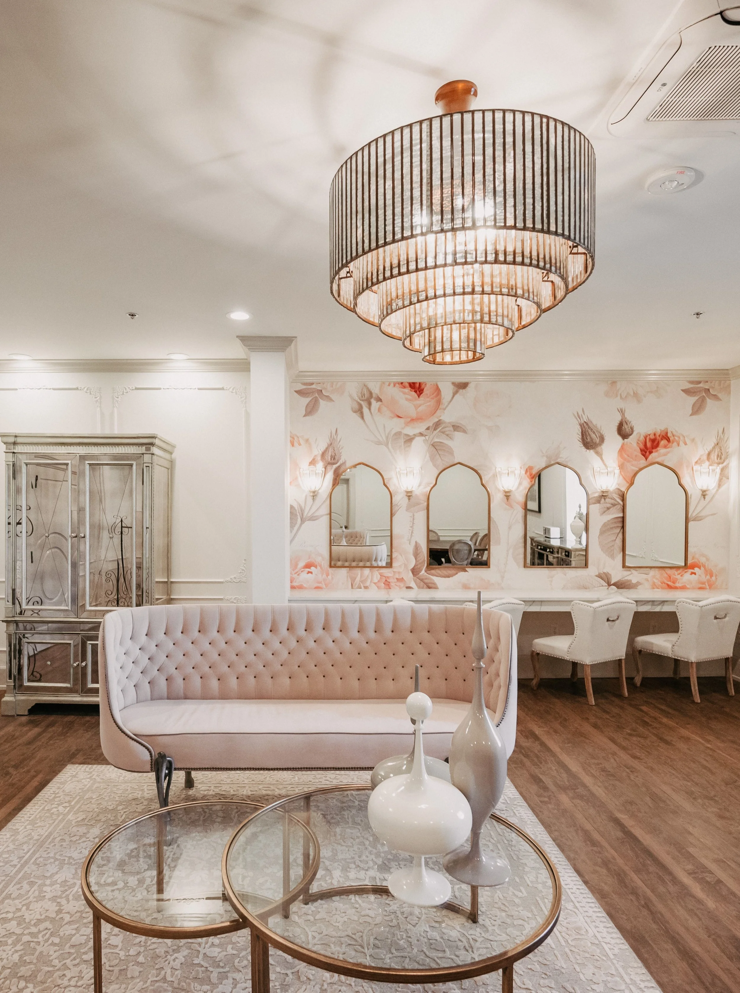 Duchess Suite bridal getting ready space featuring plush seating, chandeliers, and makeup stations.