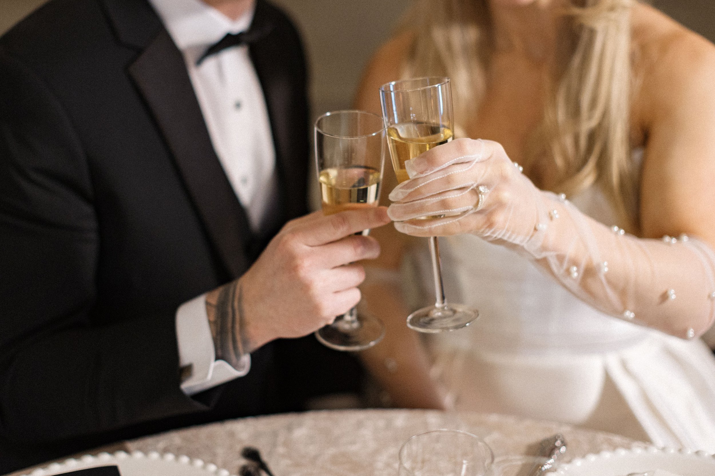 Bride and groom toasting with champagne inside The Abbey