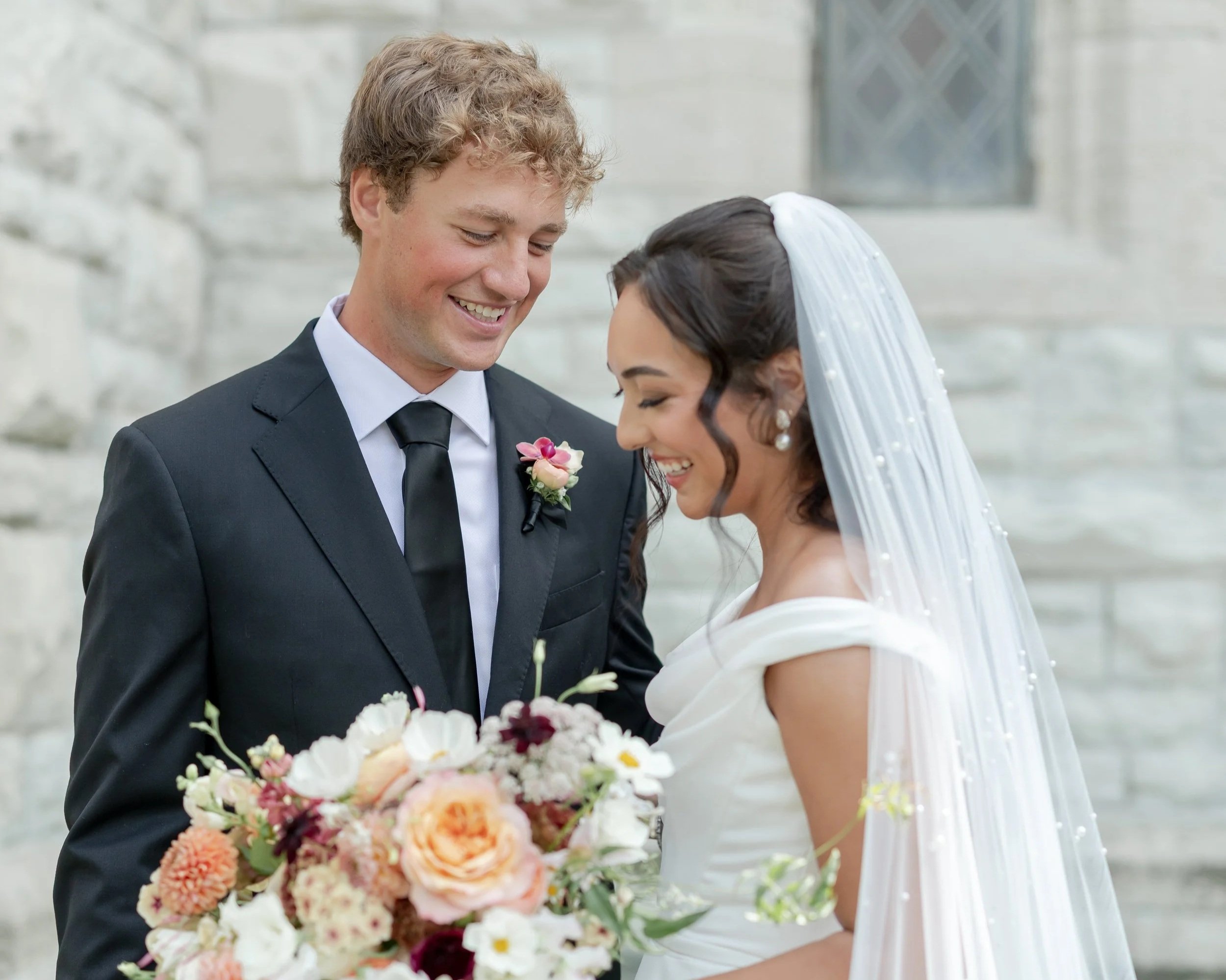 Milwaukee wedding couple laughing together during an outdoor portrait session