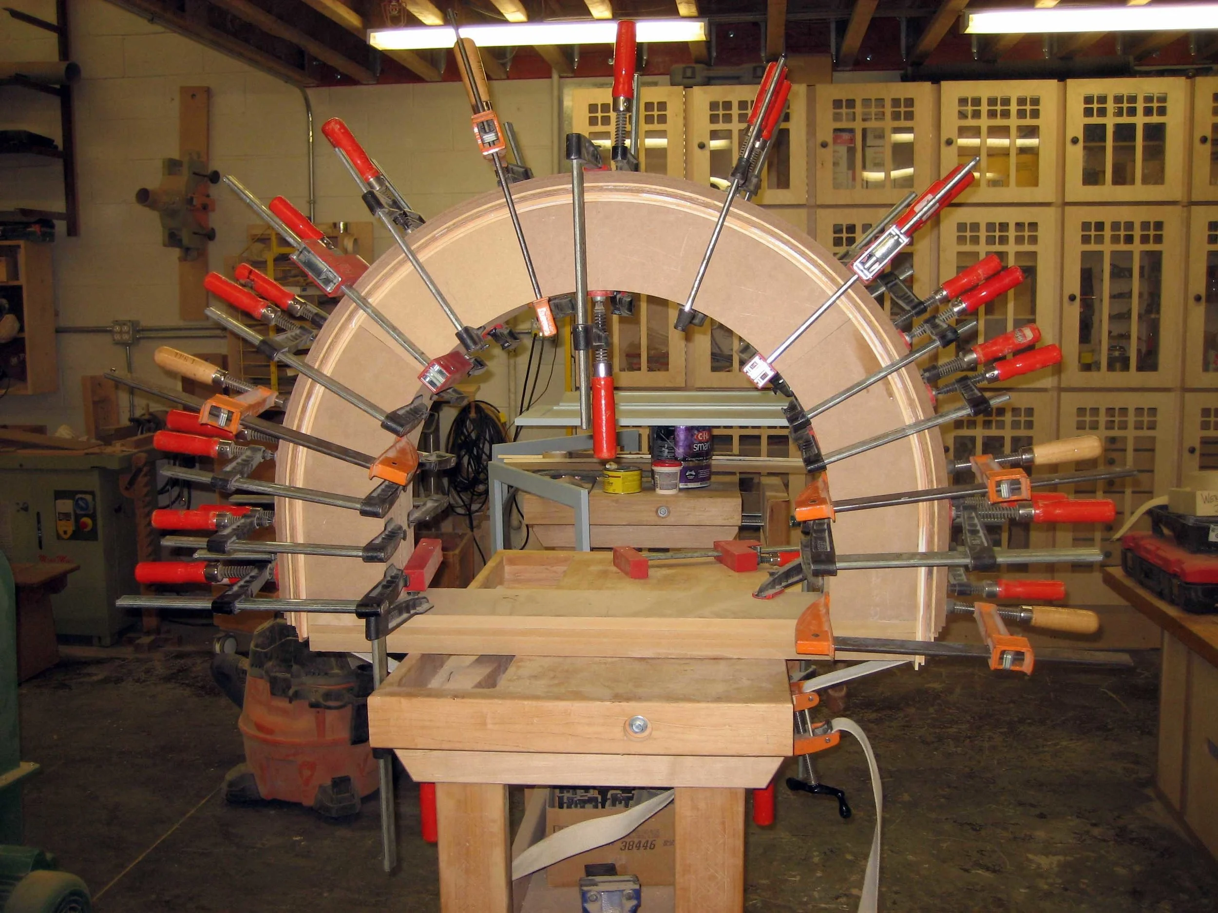 23 – Changing gears. Gluing up the curved jamb on a large particle board bending form.