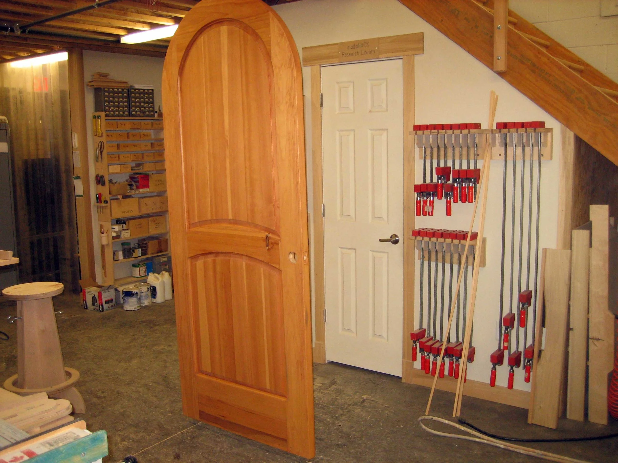 38 – An eyelet at the top of the door secured to the ceiling allowed us to finish both sides of the door at the same time.