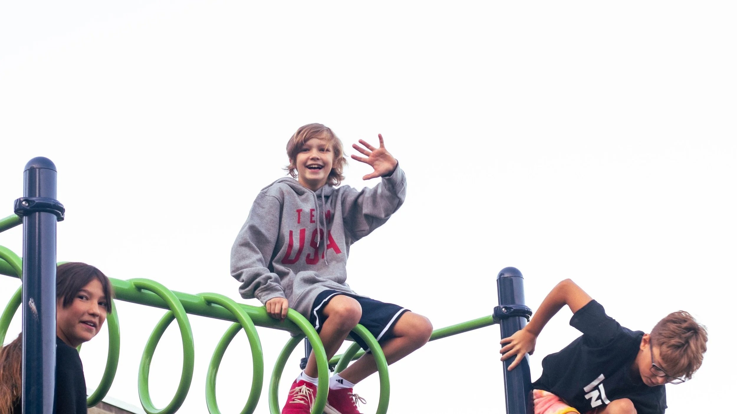 Intermountain Christian School Student Welcomes new students to his school from on top of the playground.