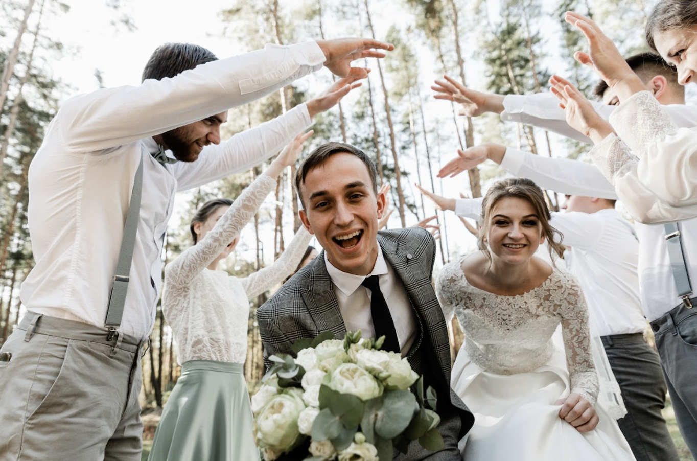 Grooms men arm tunnel wedding entrance