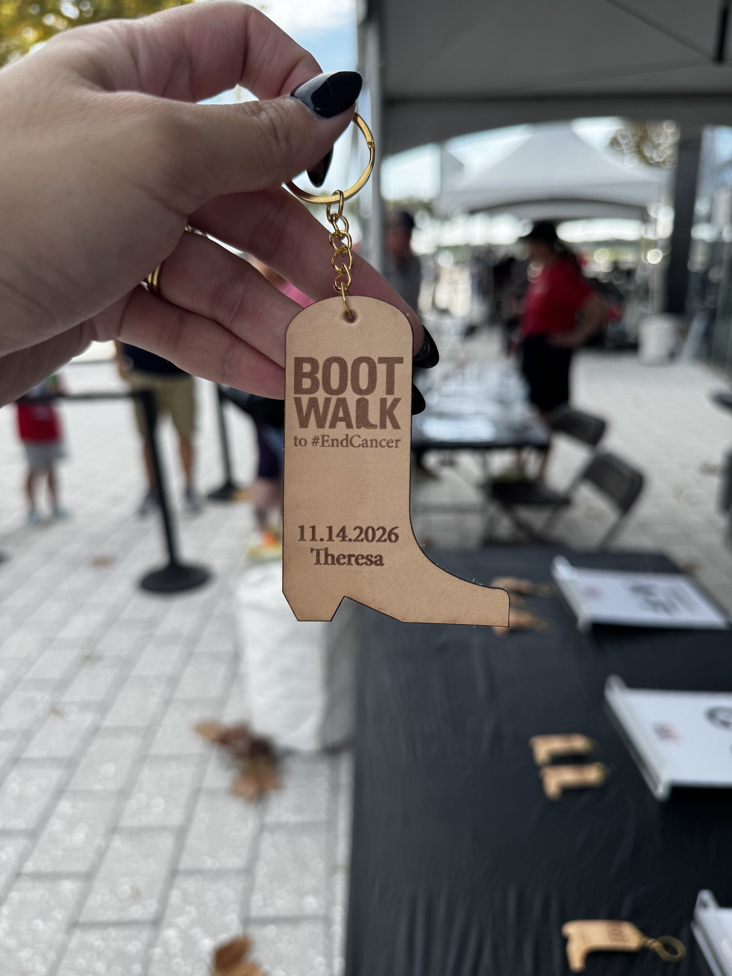 Close up view of Leather keychain with boot walk logo pre engraved and name and date engraved on site