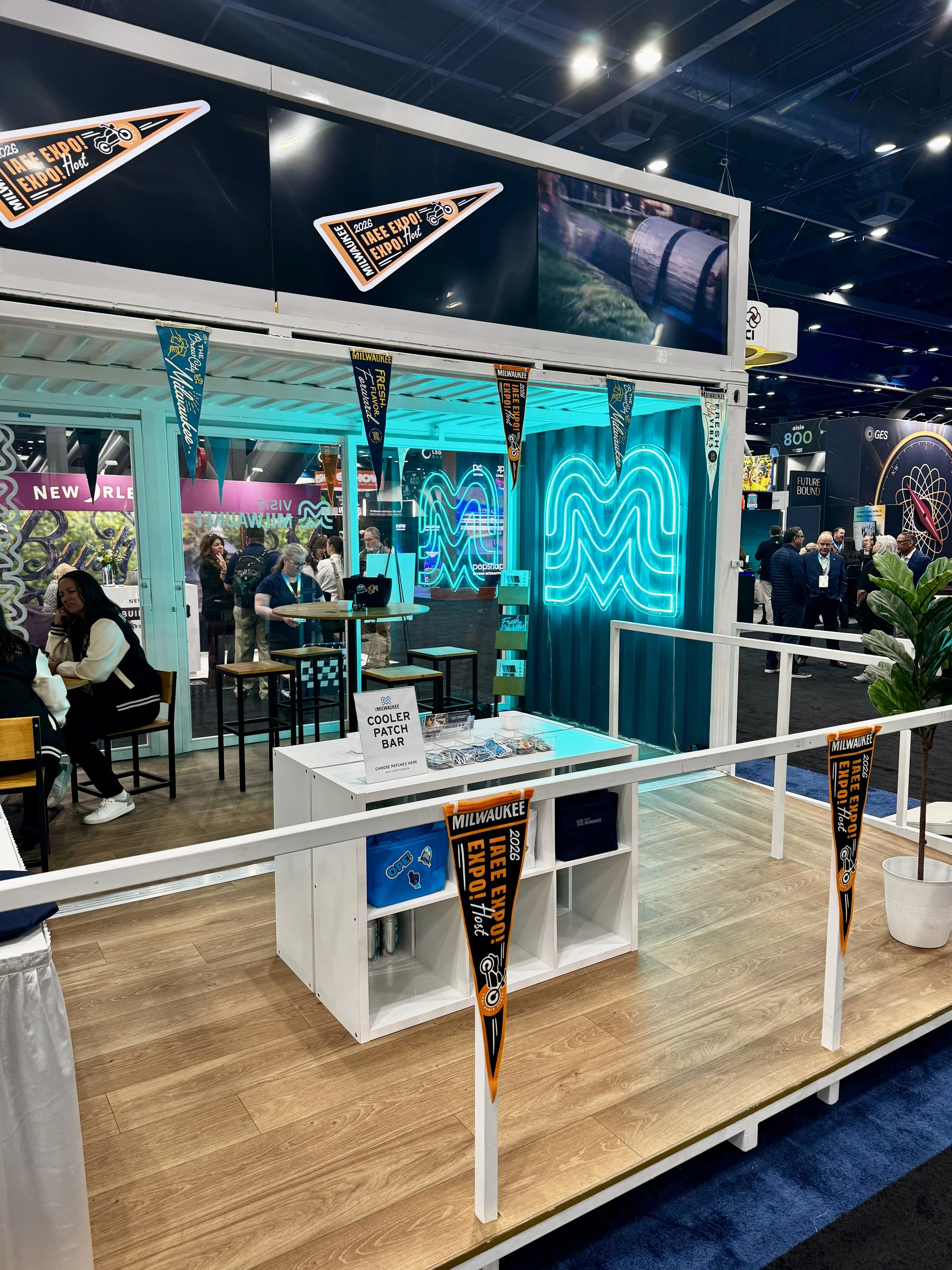 Milwaukee booth set up at expo expo 2025 featuring a live heat pressing patch bar
