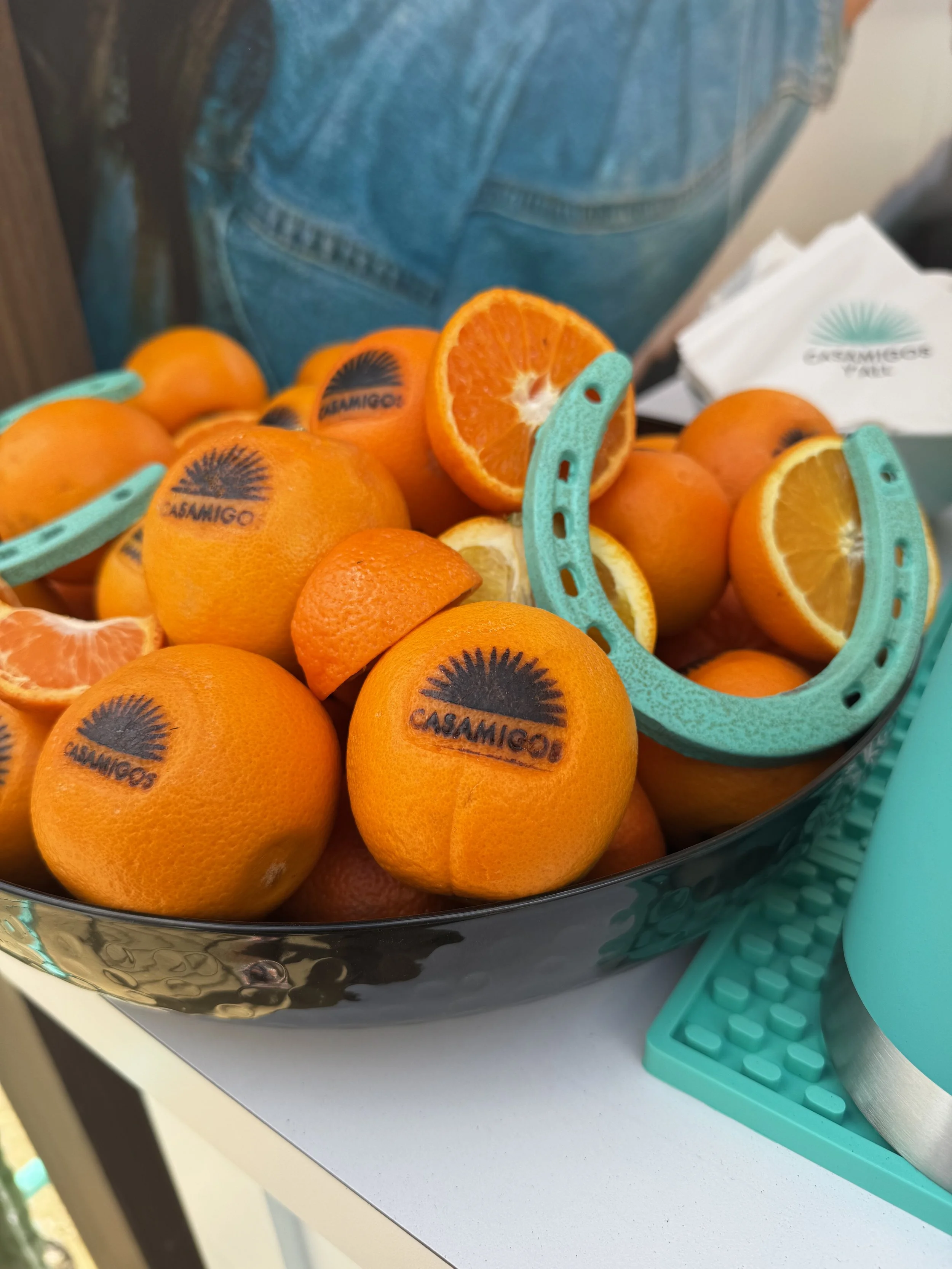 bowl of oranges branded with casamigos logo at live heat press event.
