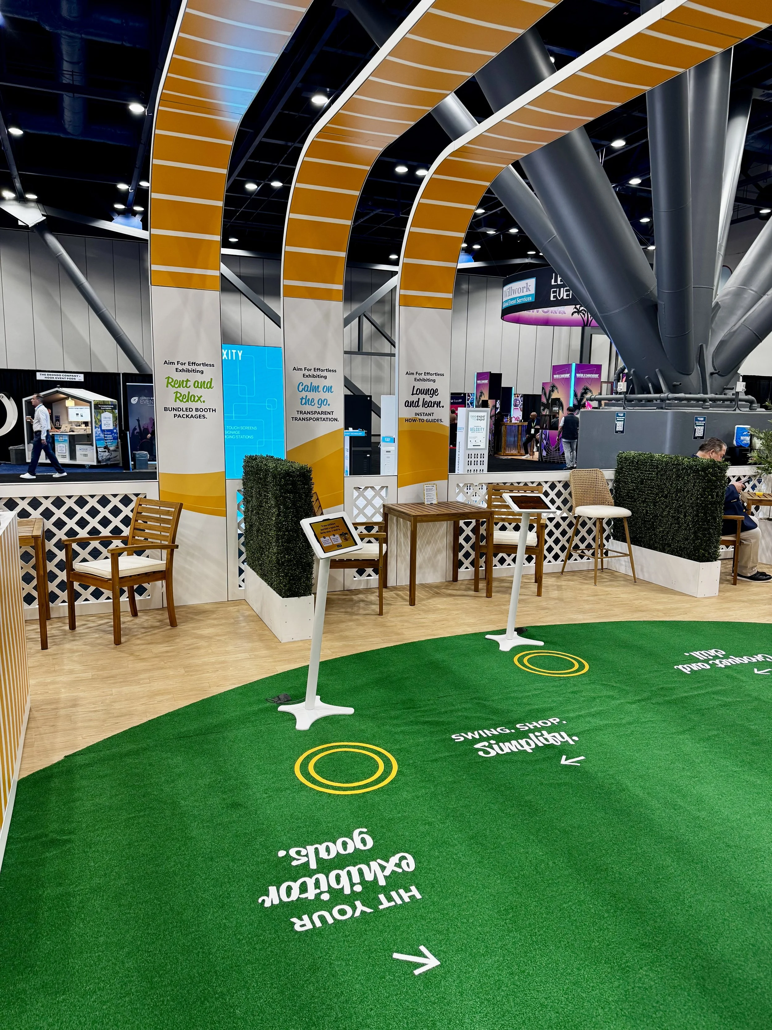 Set up for large footprint booth with seating and ipads for info at freeman booth during expo expo 2025