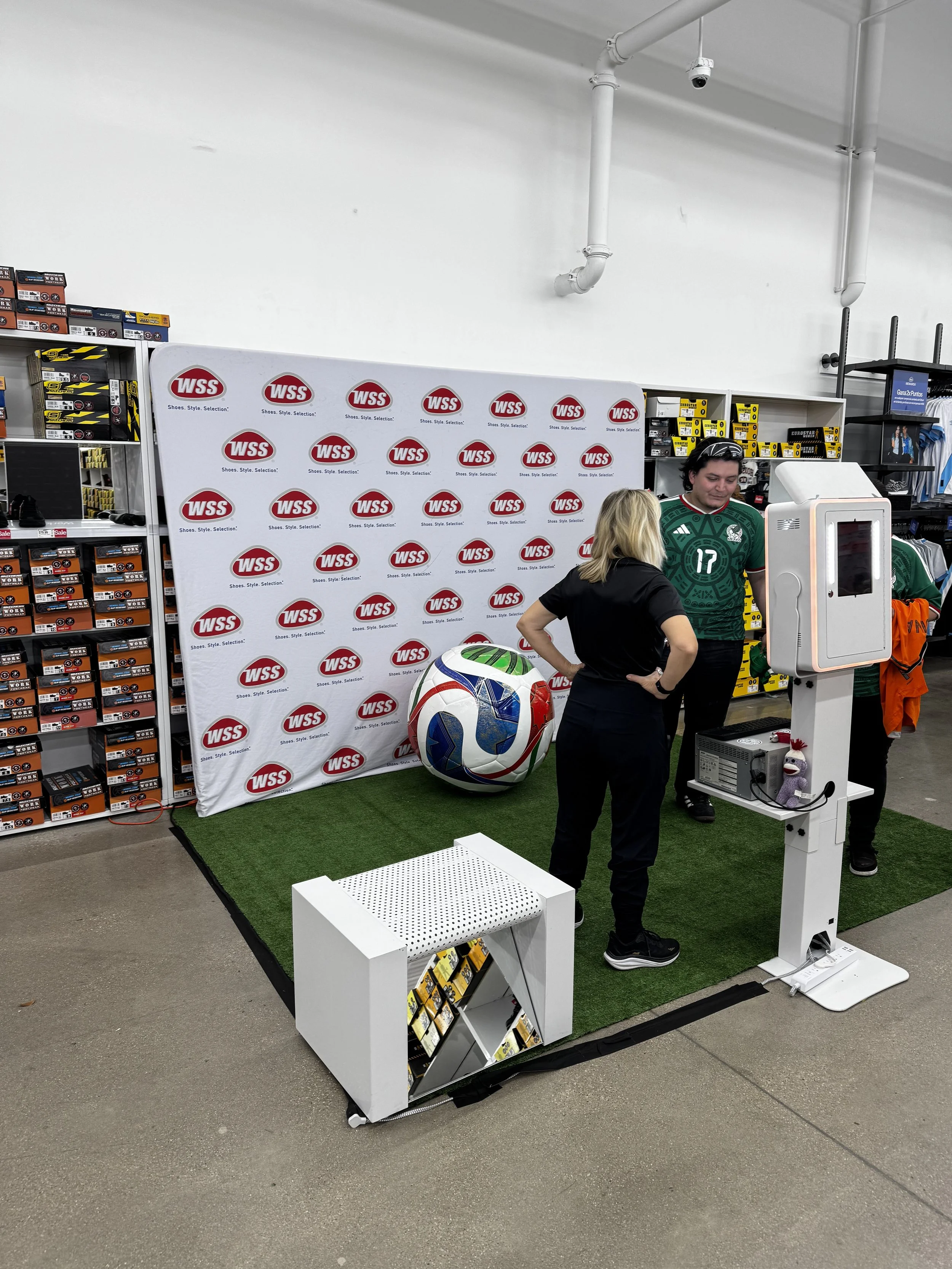 Photo booth with giant soccer ball for people to pose with and have photos taken with Hector or friends and family