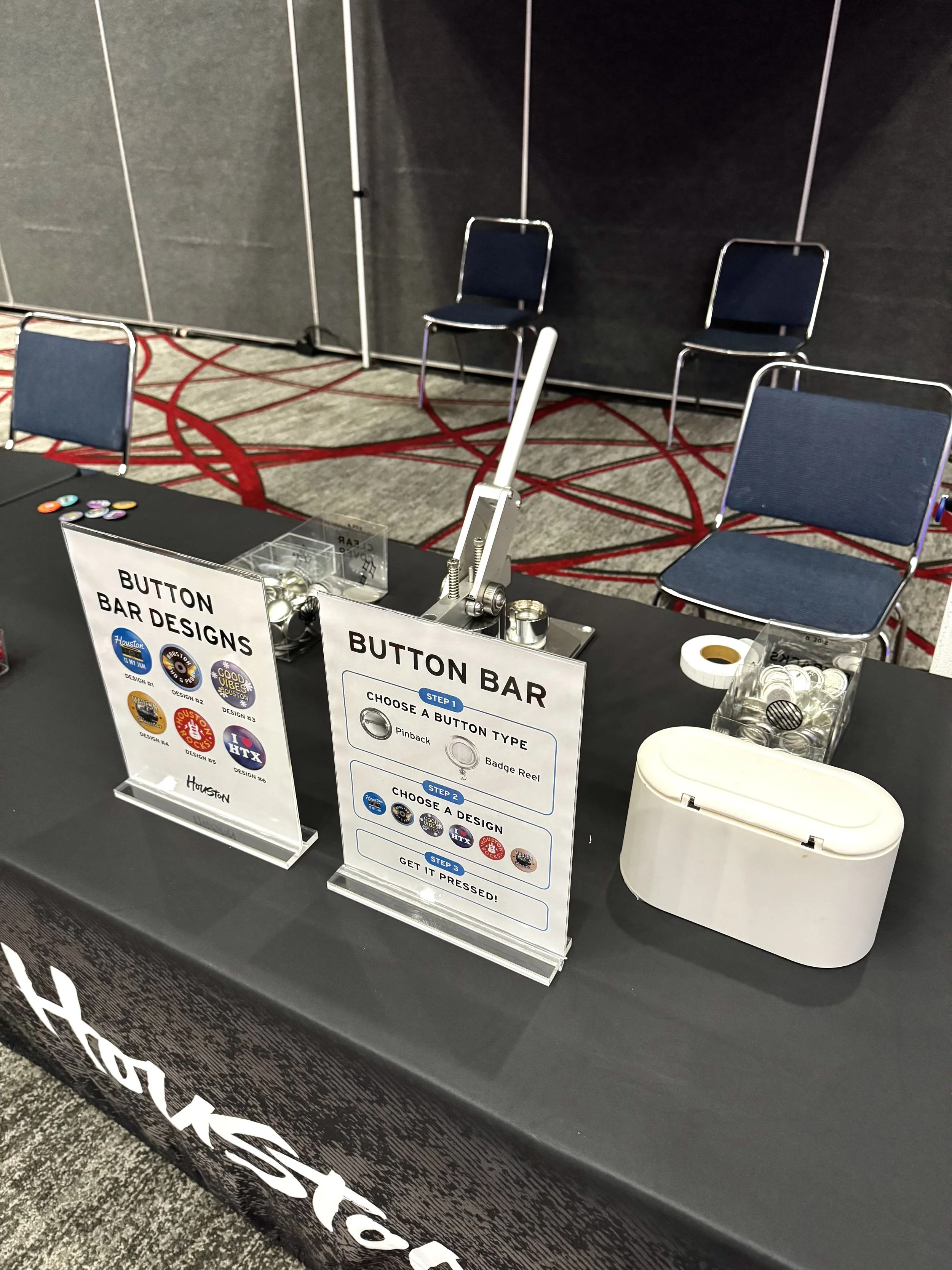 Descriptive signage and equipment set up for live button making station