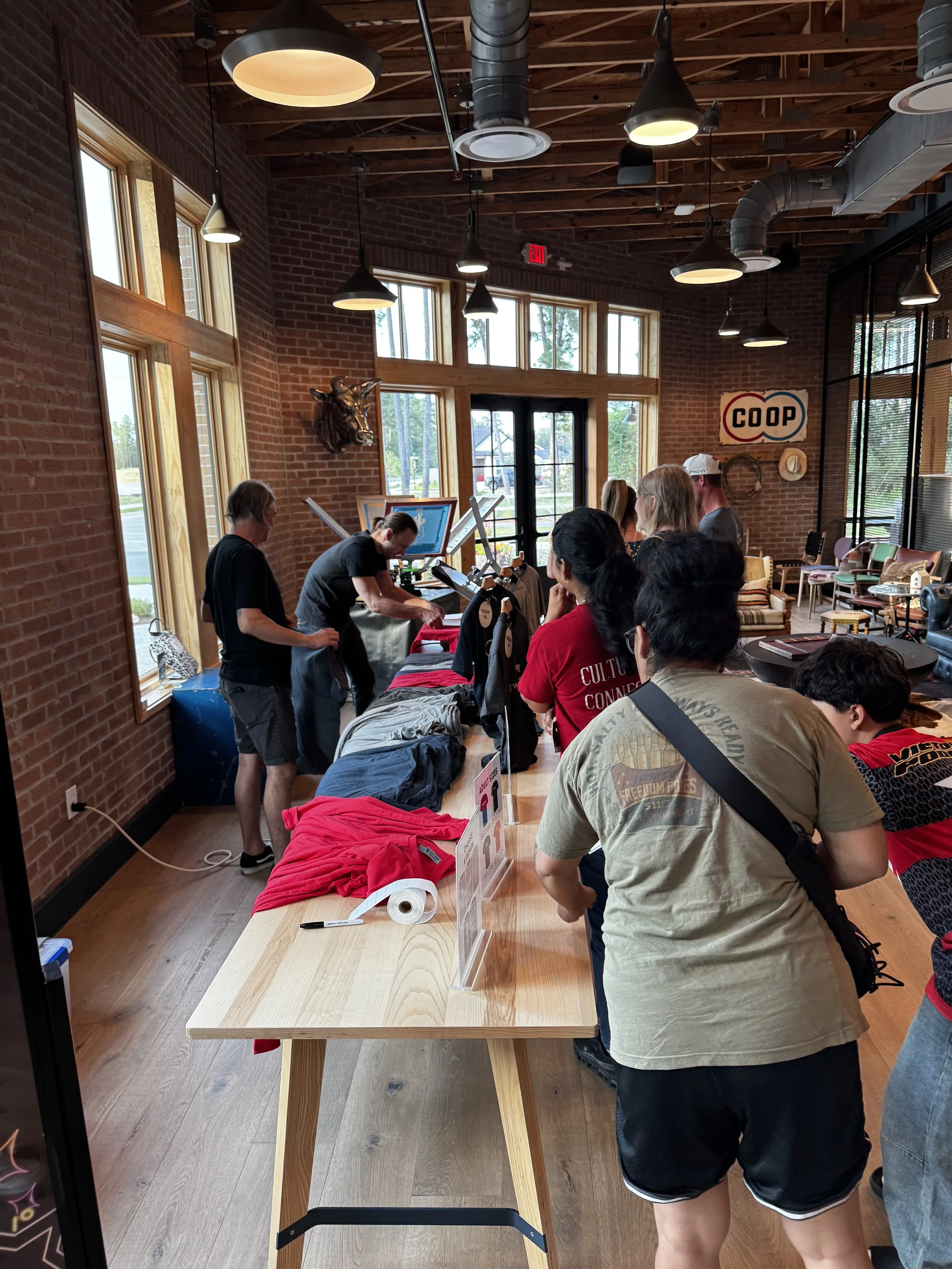 Guests line up to select their shirts from 4 design options and 4 color shirts