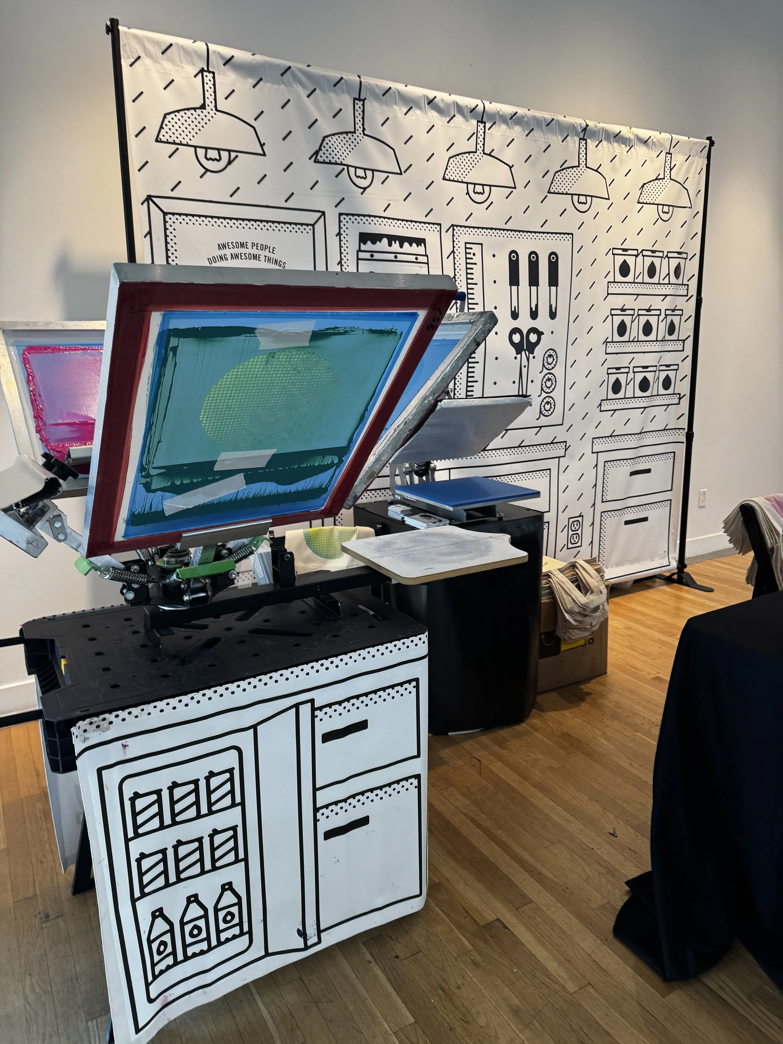 set up of our 4 screen print press and heat press which allows the ink to cure and later for the monograms to be applied