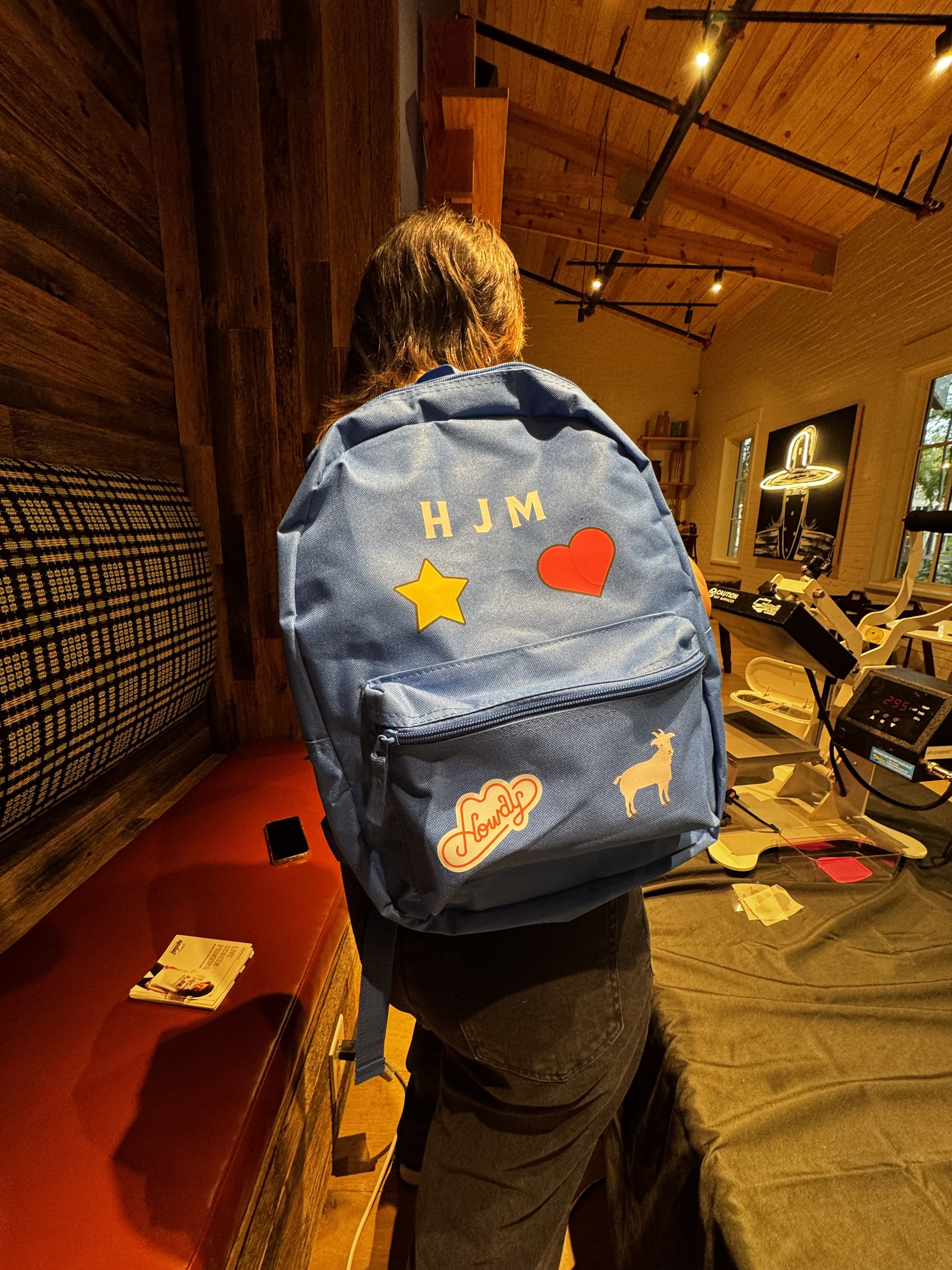 Monogrammed backpack with full color decals heat pressed live on site