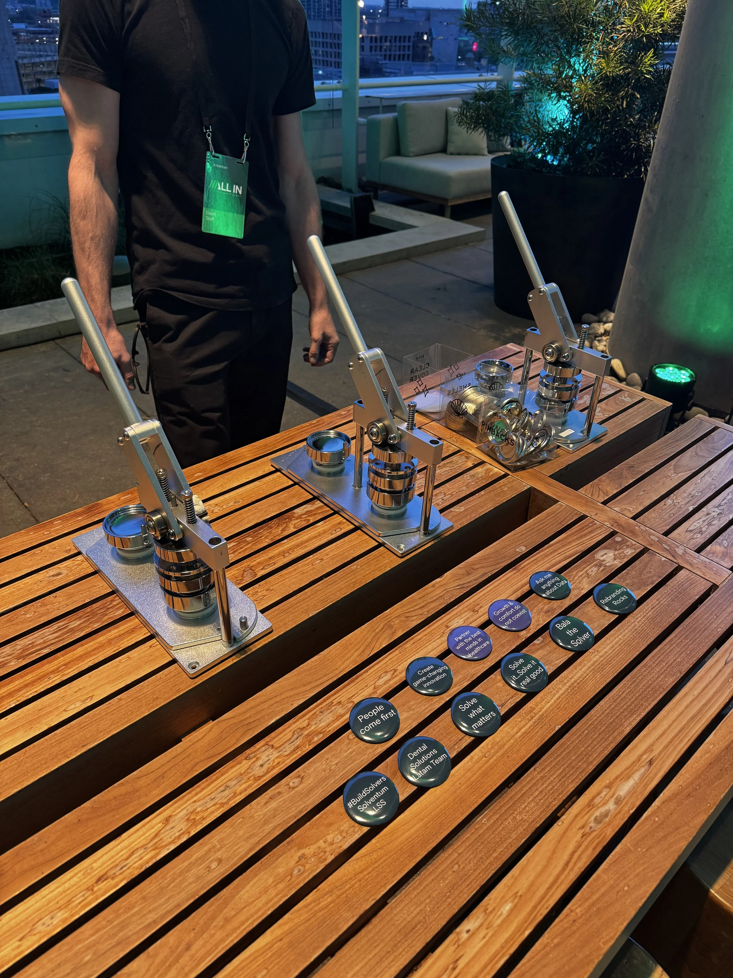 Examples of some of the phrases guests chose to have printed onto their buttons laid out in front of our button presses