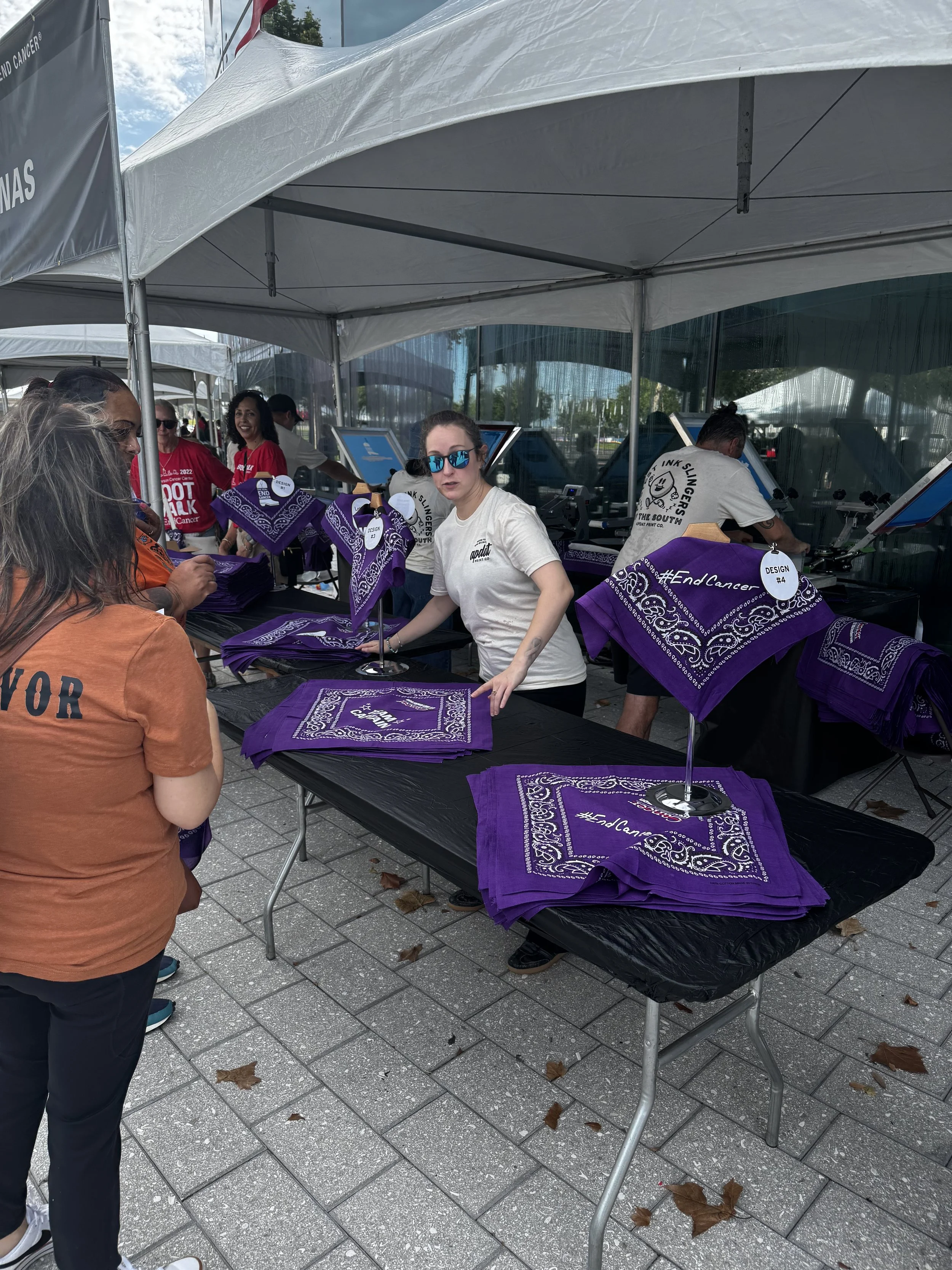 Table layout showing stacks of on site printed bandanas