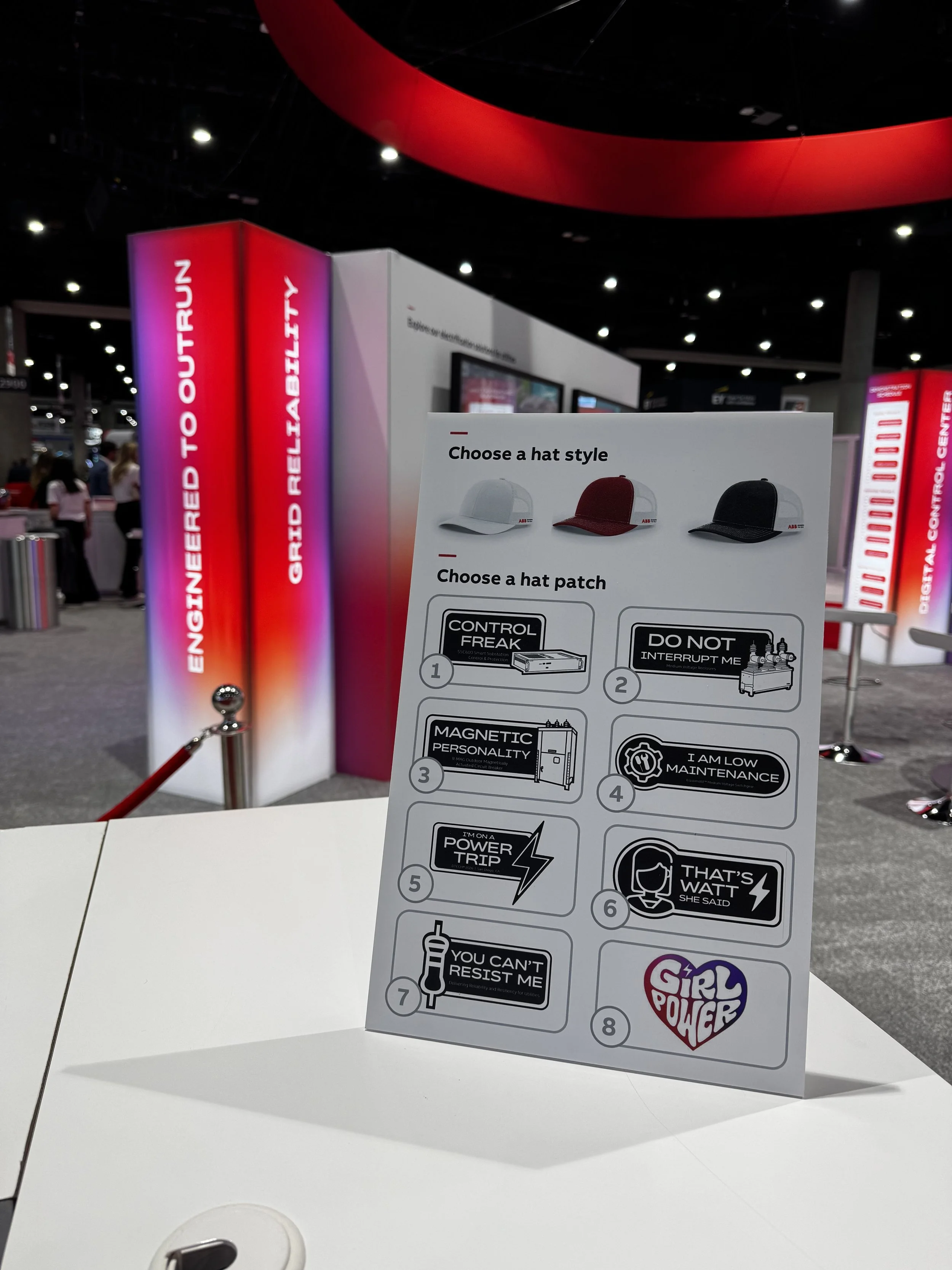 Sign showing the patches available to be heat pressed onto hats live on site at abb dtech booth