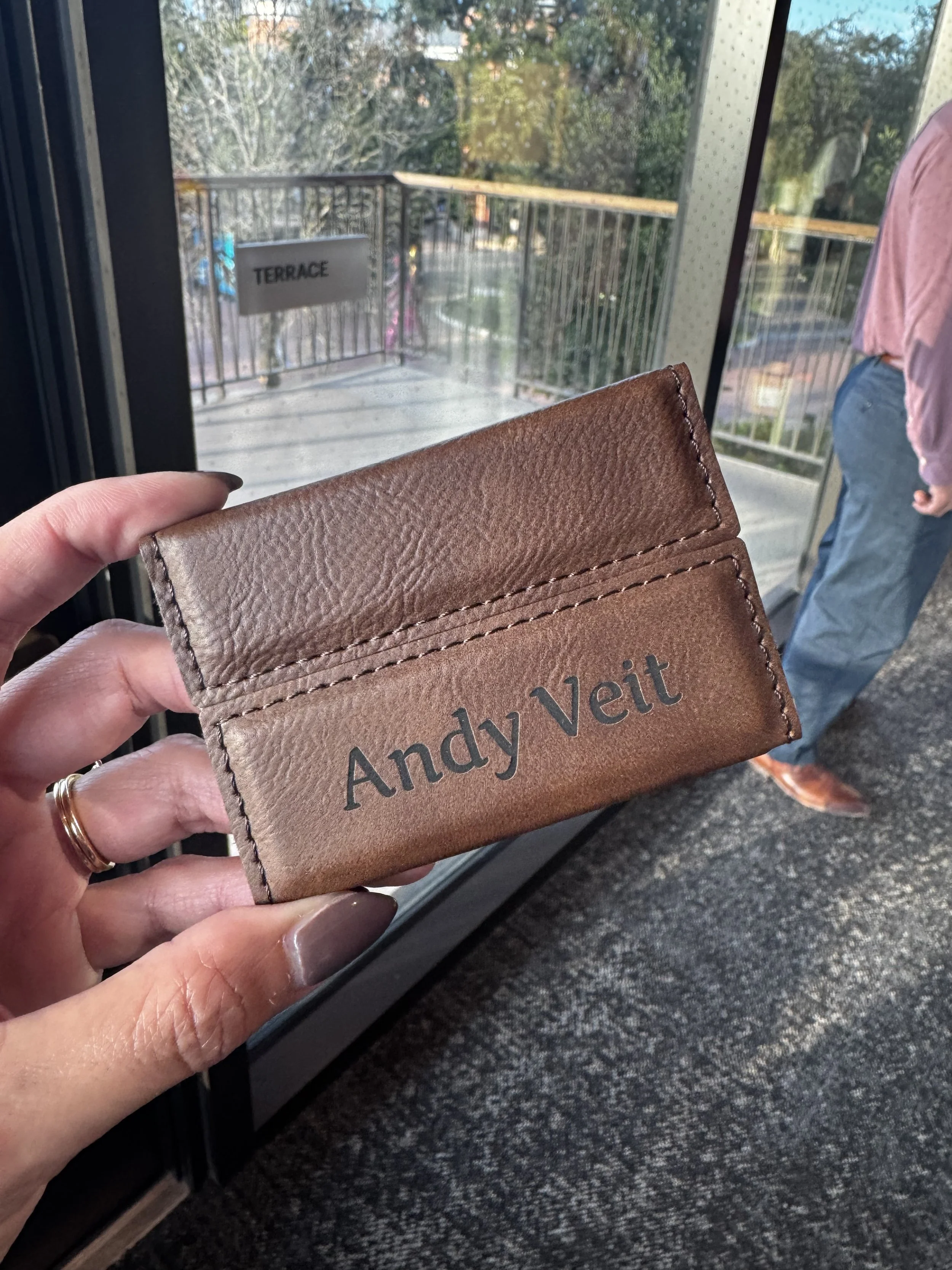 Example of Leatherette business card holder engraved live on site at kirkland ellis event