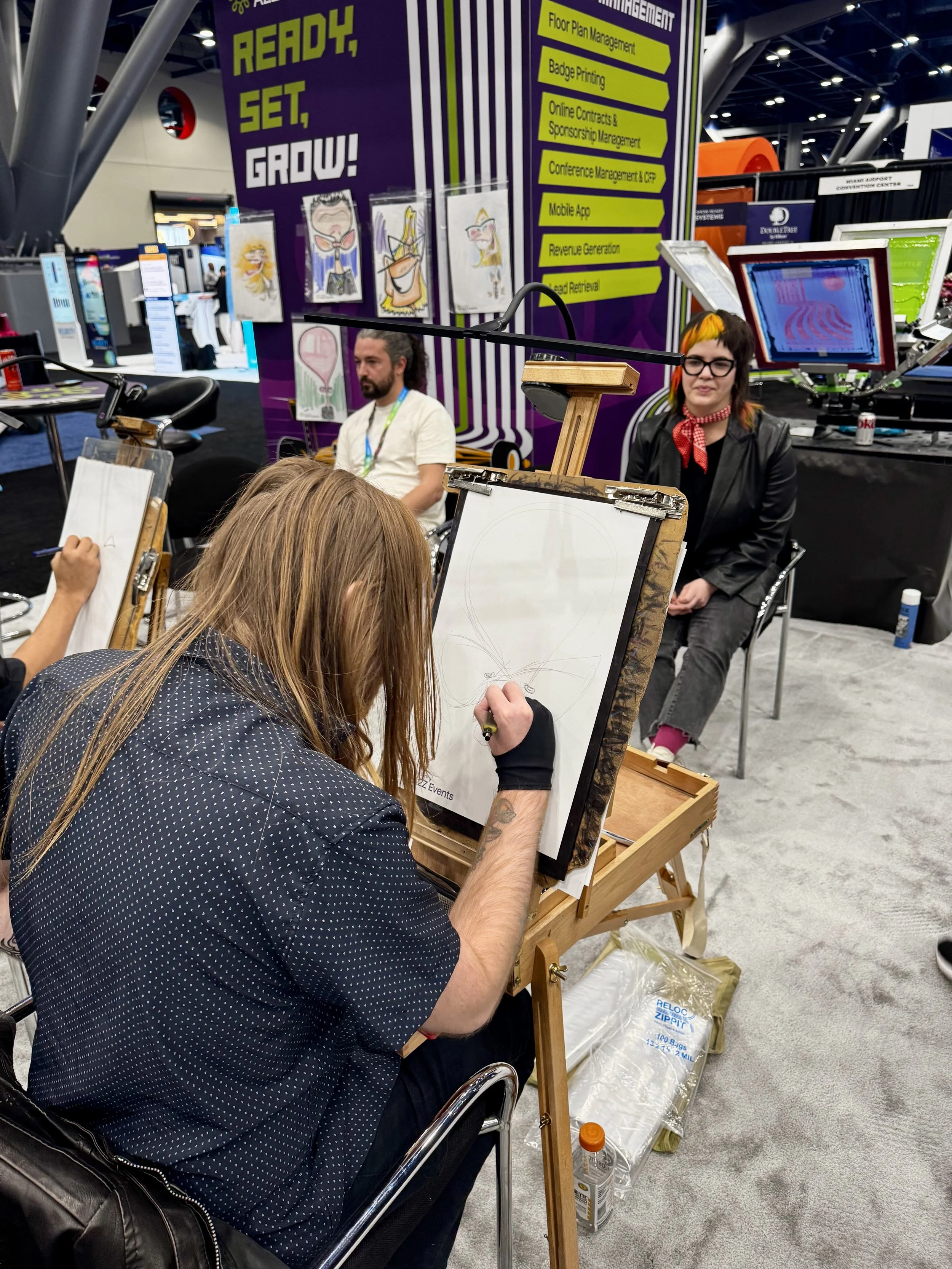 Artist Joey "Snappy" Stettner captures the likeness of an apdat employee at personify's booth at expo expo 2025