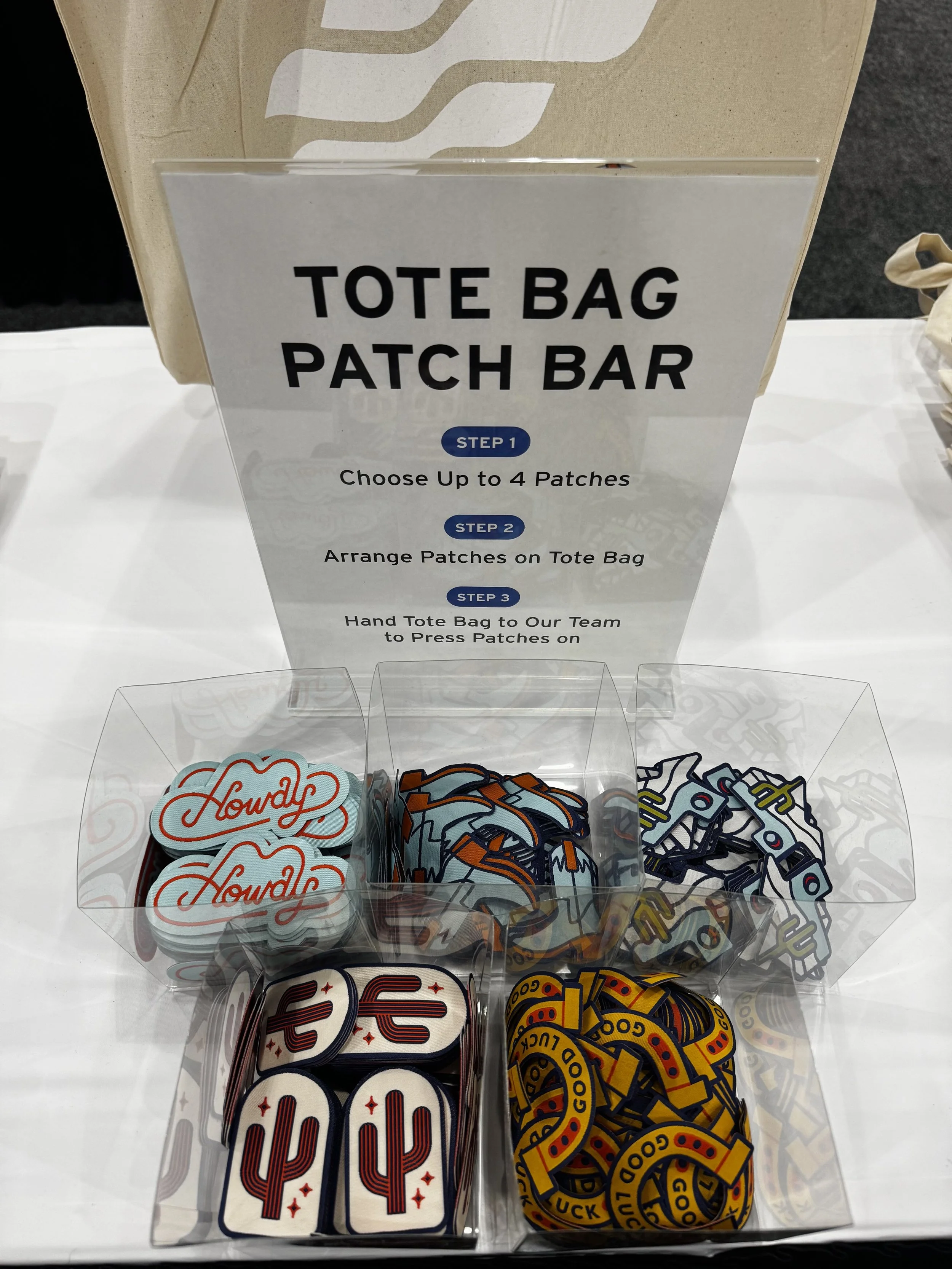 Dishes holding all the patch options available for guests to have heat pressed to their totes