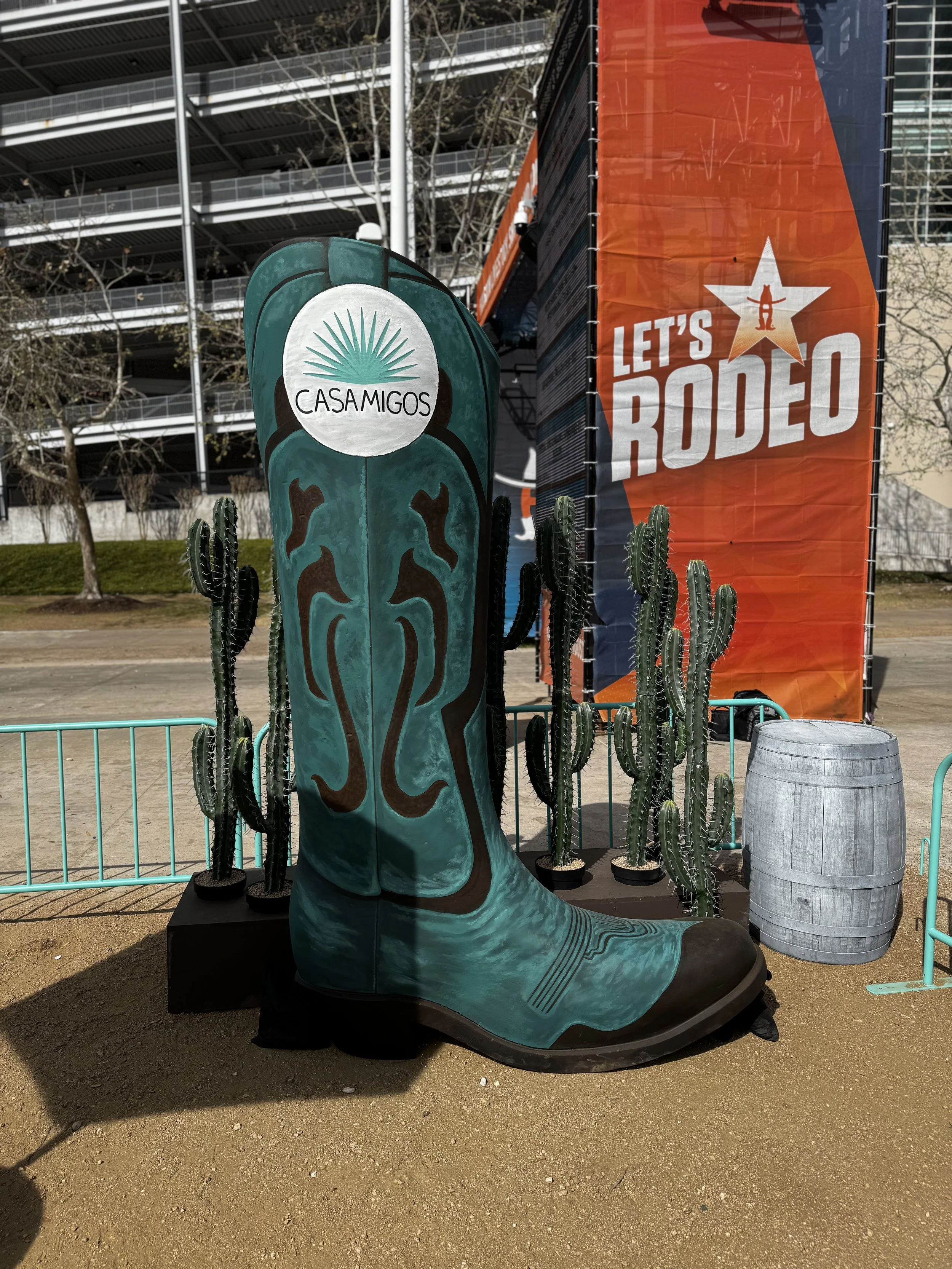 Oversized Turquoise cowboy boot with casamigos branding part of display at live heat press event at houston rodeo.