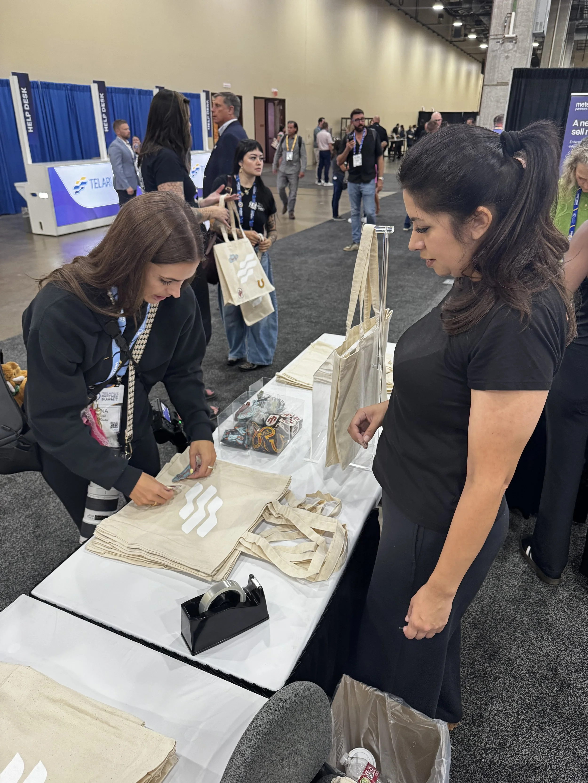 Guests arranging their patches of choice onto the telarus tote bags