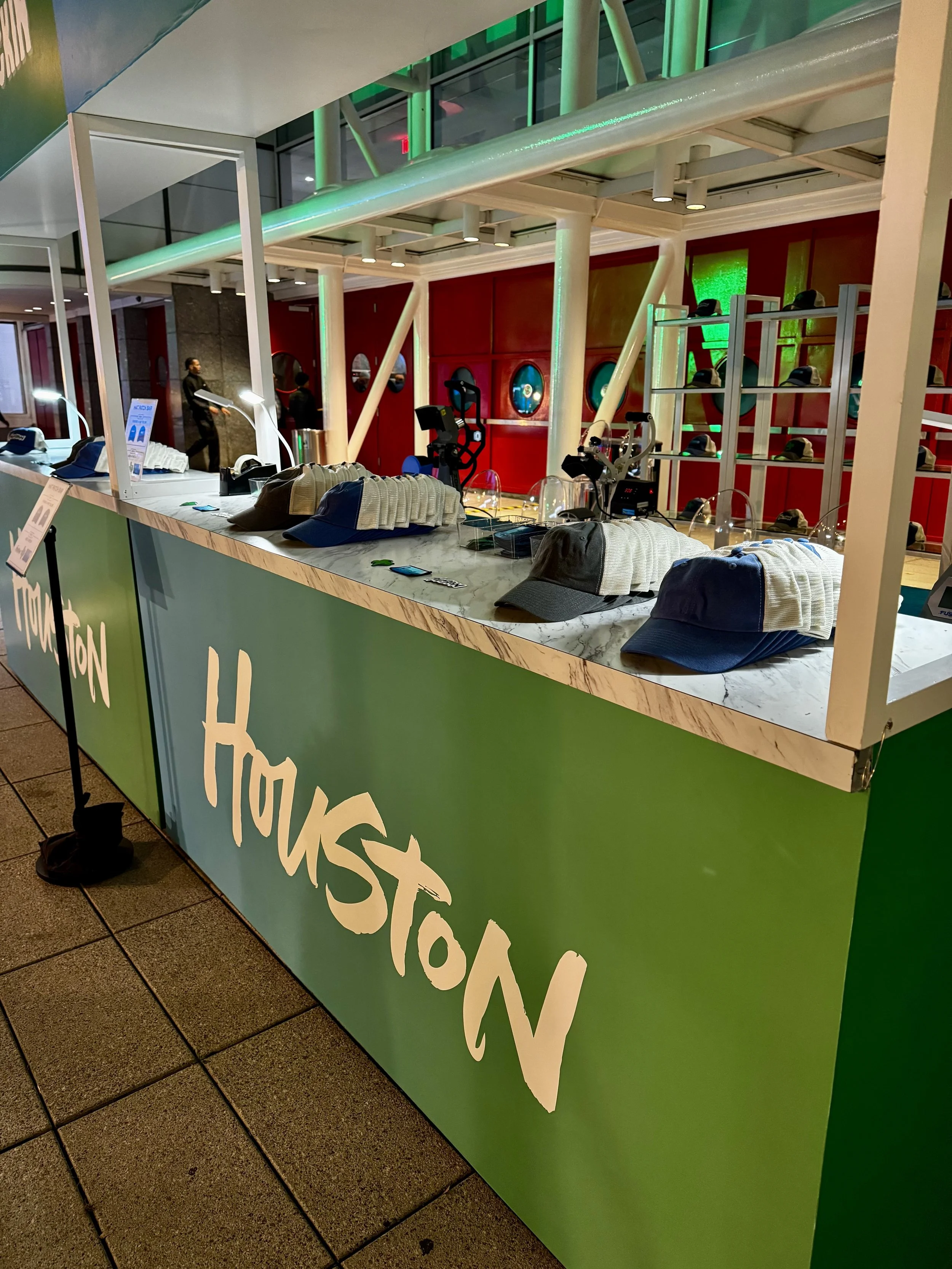 view from the side of hats on display ready to have custom woven patches pressed onto them live