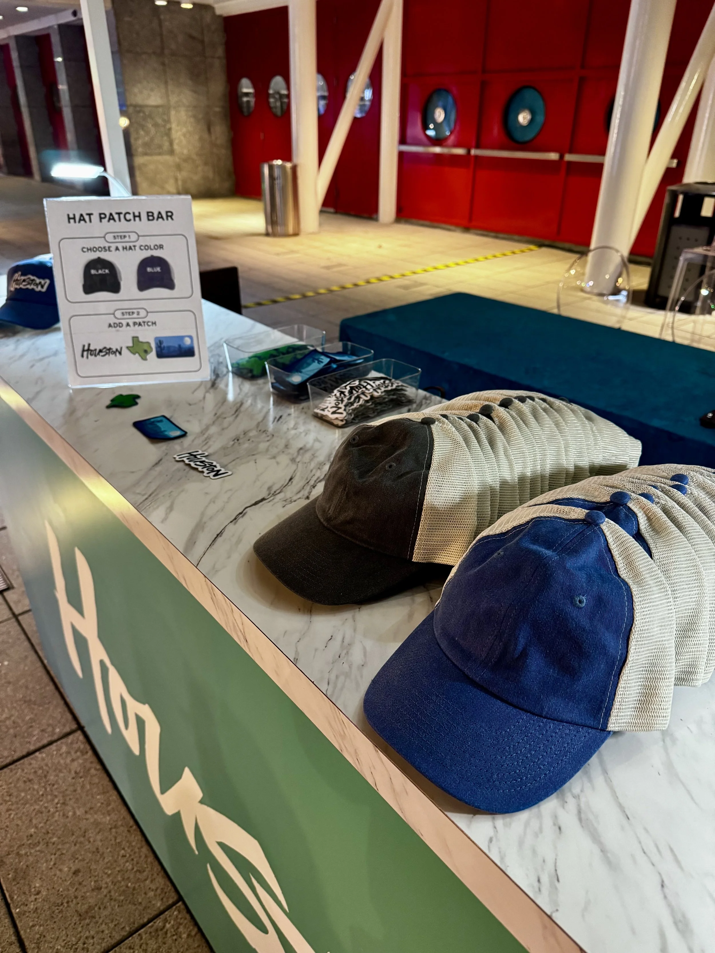 hat bar where you can see display of hats and patches ready to be combined into perfect convention merch