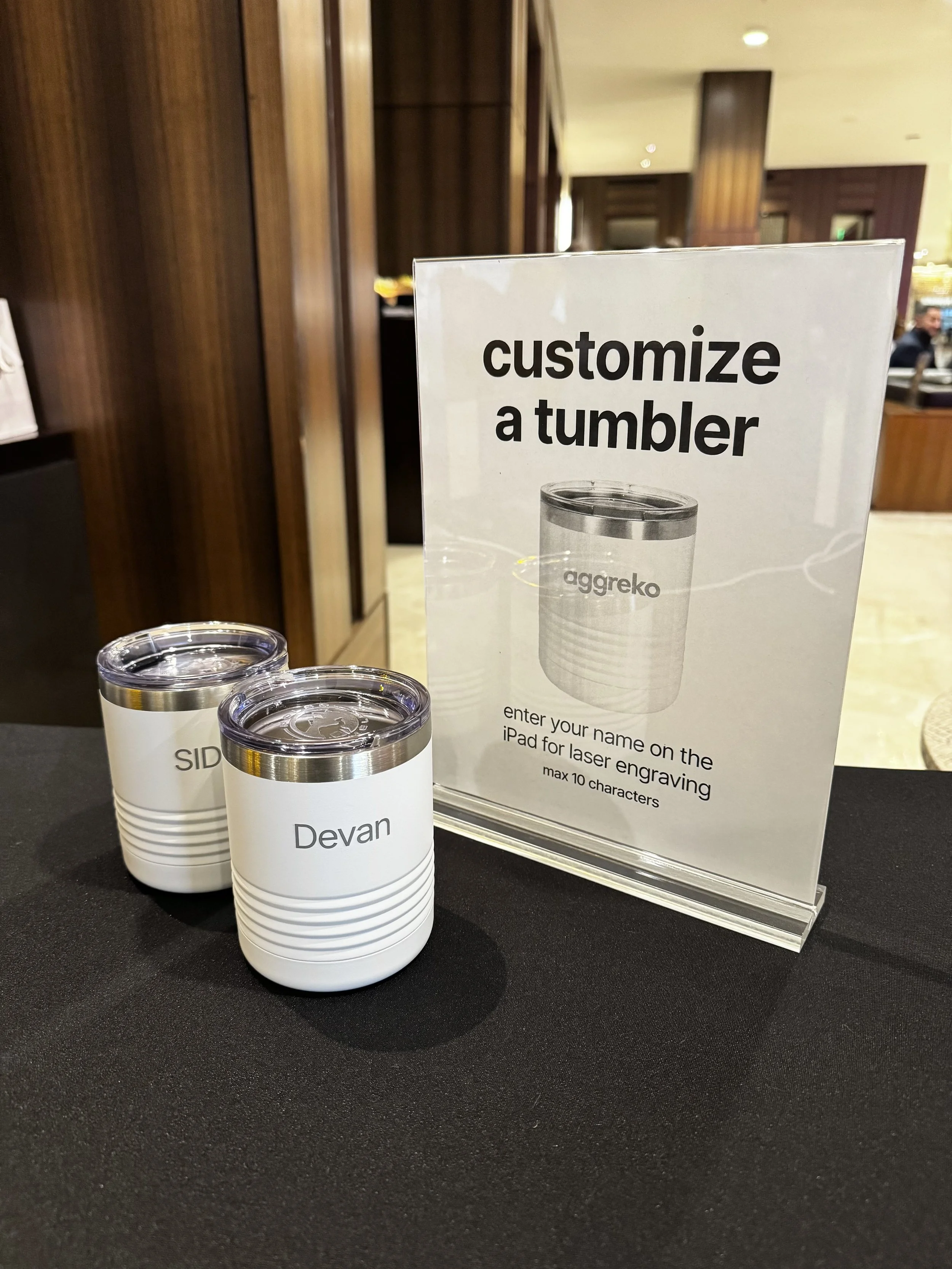 Names on sides of tumblers engraved live on site at VIP cocktail mixer for Aggreko clients