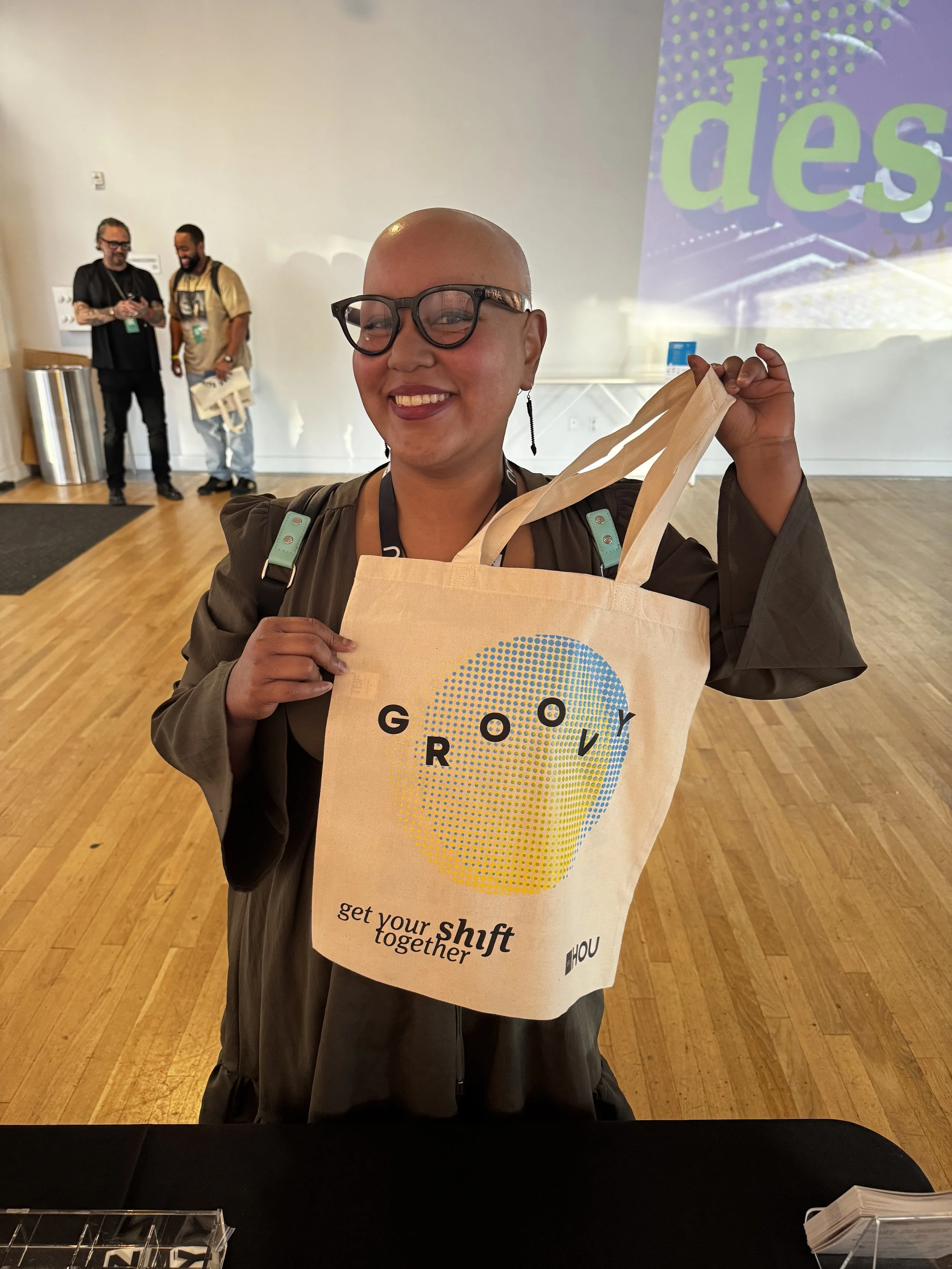 AIGA Symposium attendee holding up freshly printed tote bag