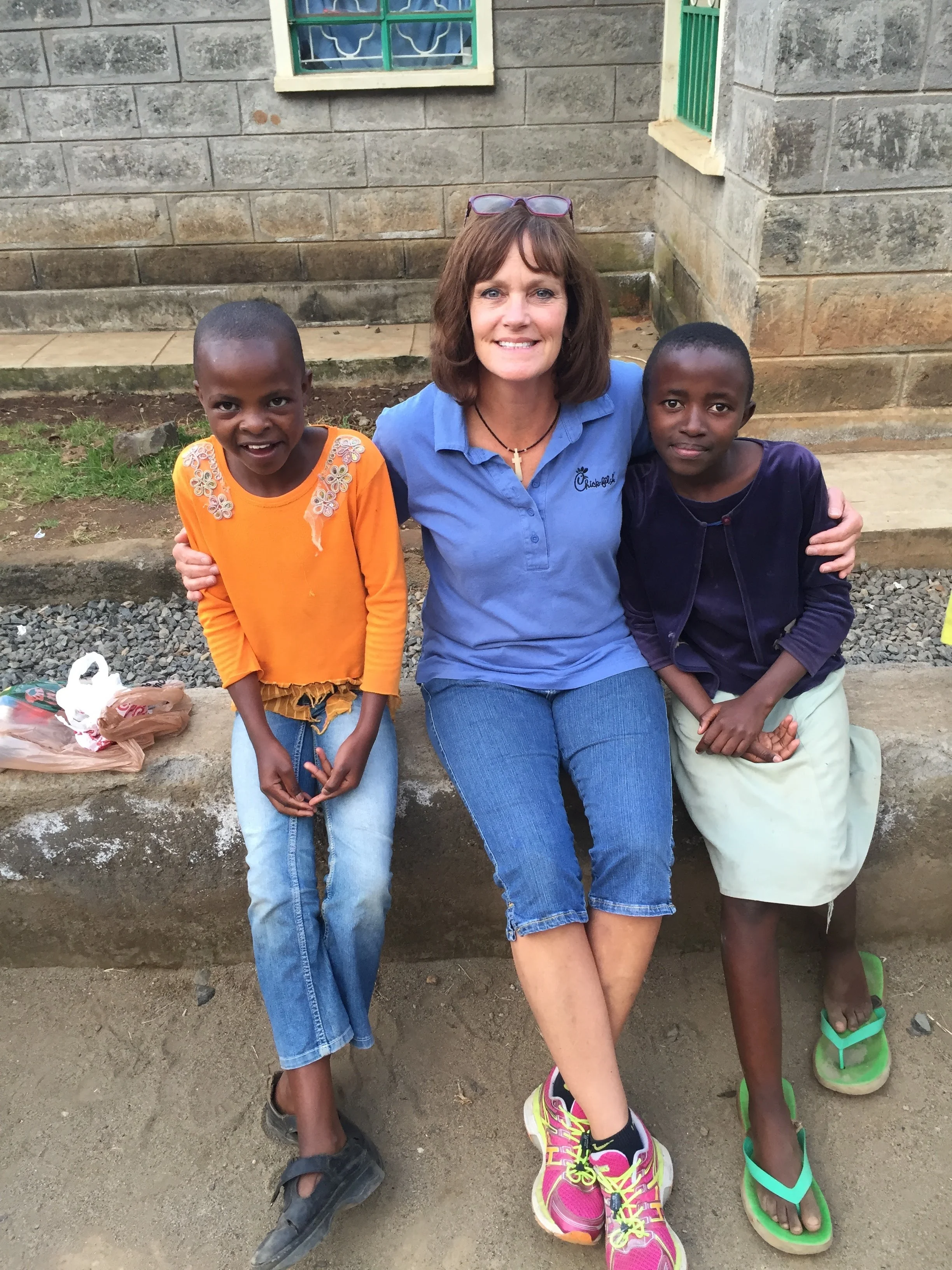 One of our frequently-visiting volunteers and two of our sweet girls who live in one of our children's homes.