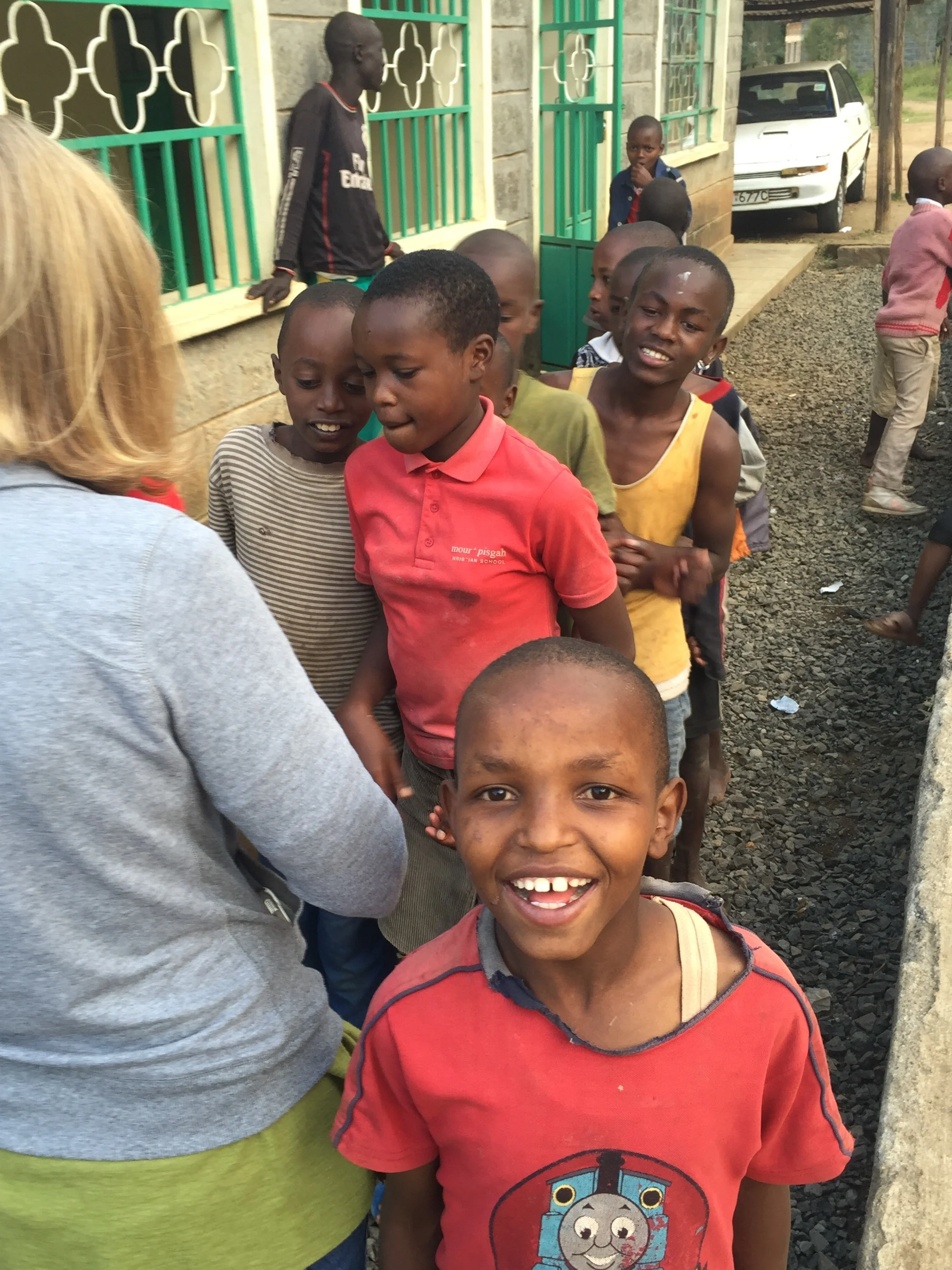 Gathering outside of one of our children's homes to receive candy from one of our volunteer groups.