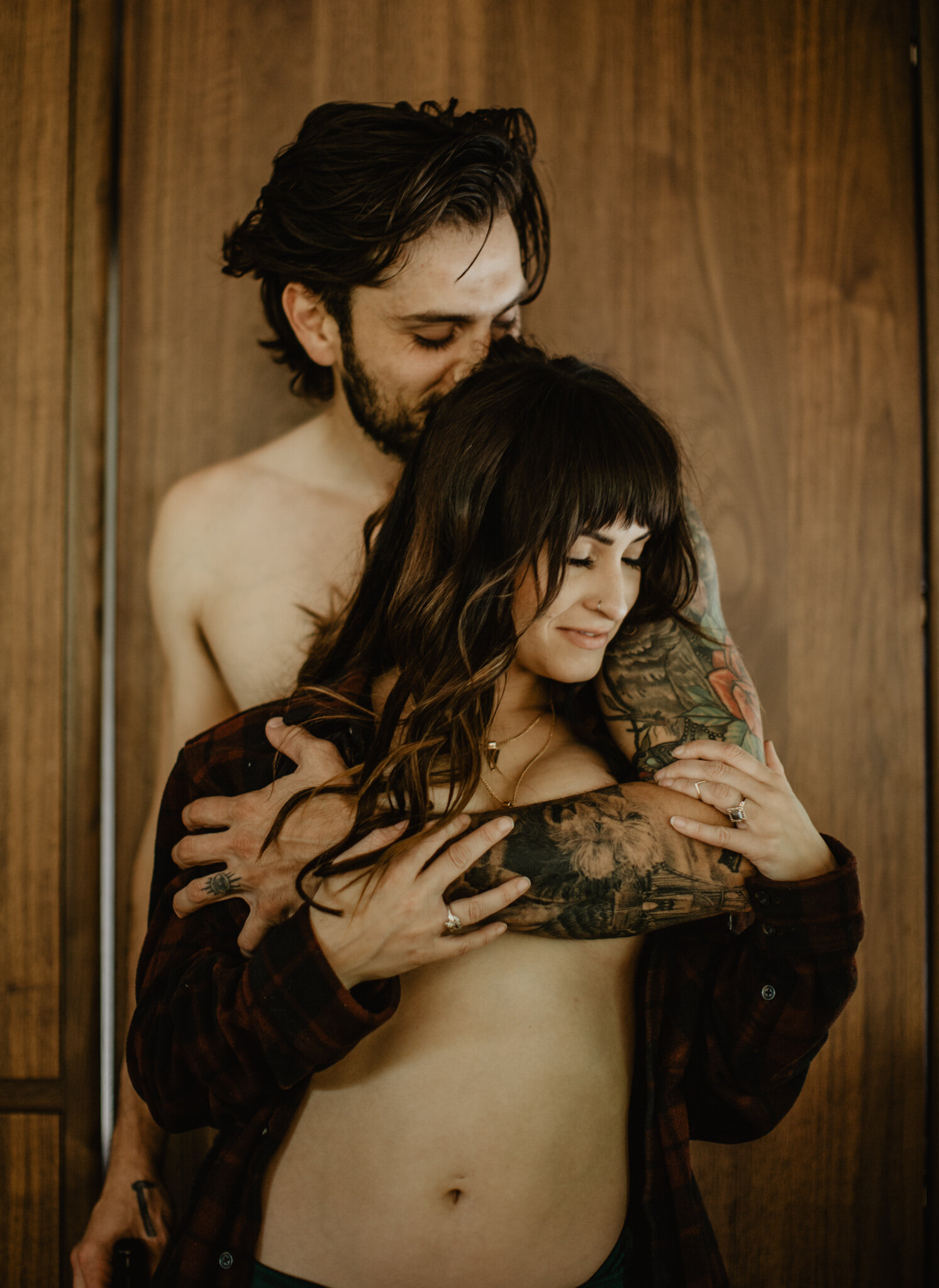 Boudoir Husband holding wife with tattoos