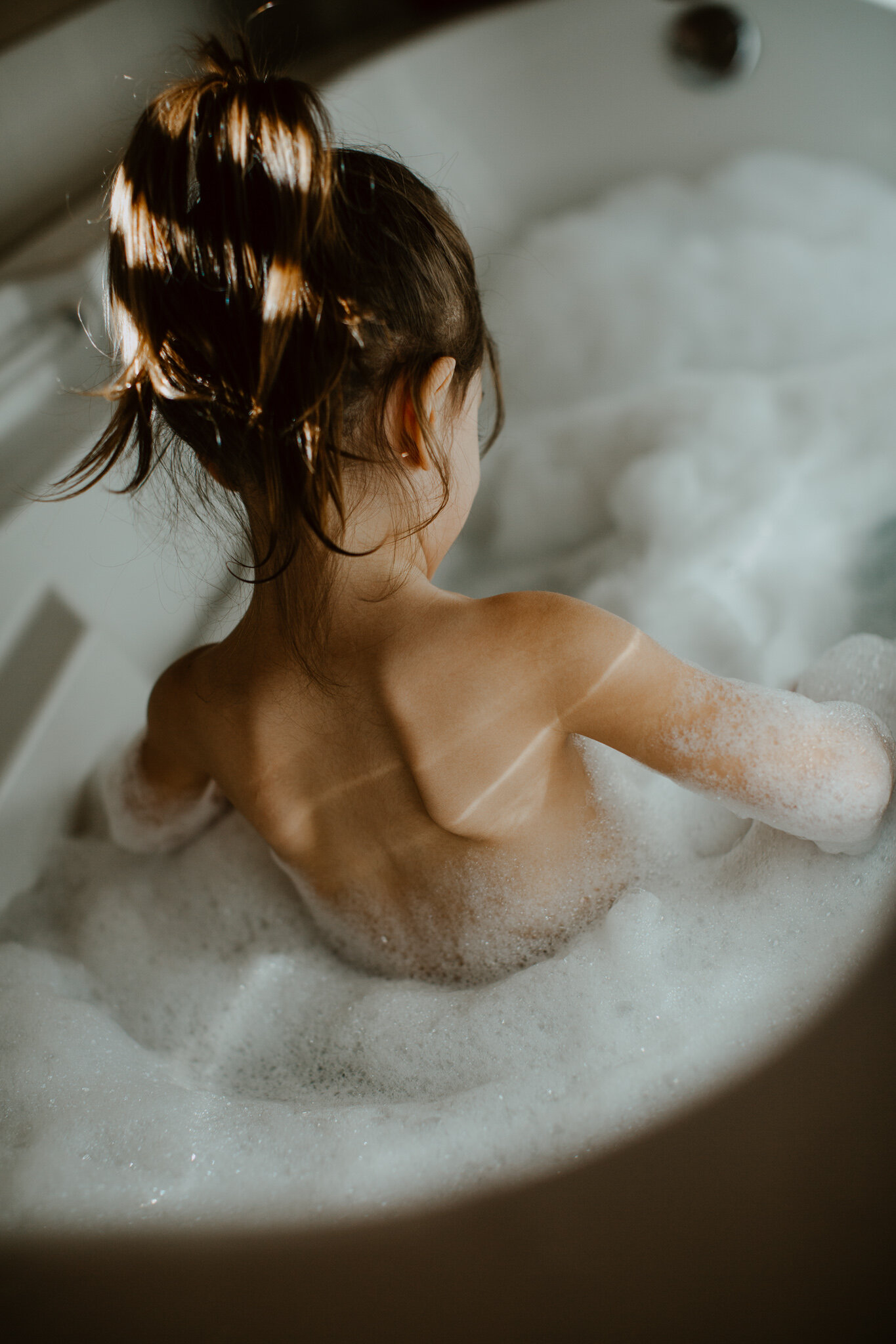 little girl in bubble bath