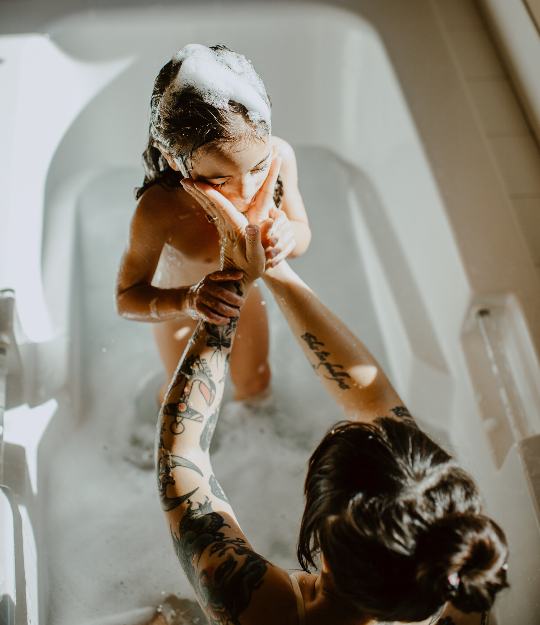 mother and child in tub with bubbles