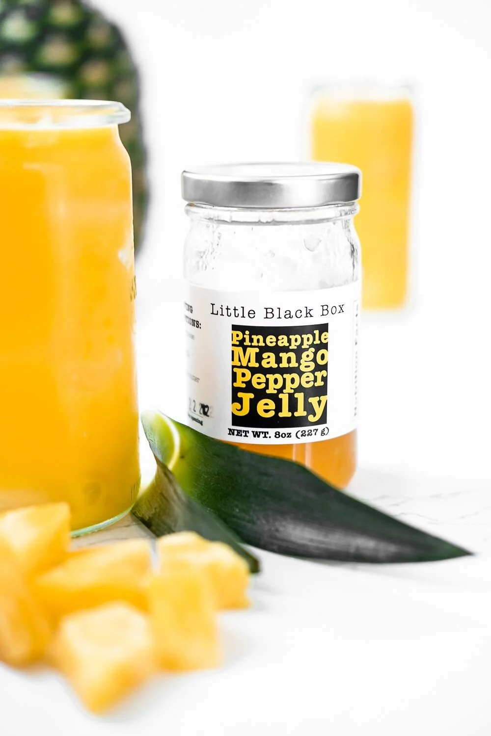 pineapple pepper jelly on a white background with pineapple leaves