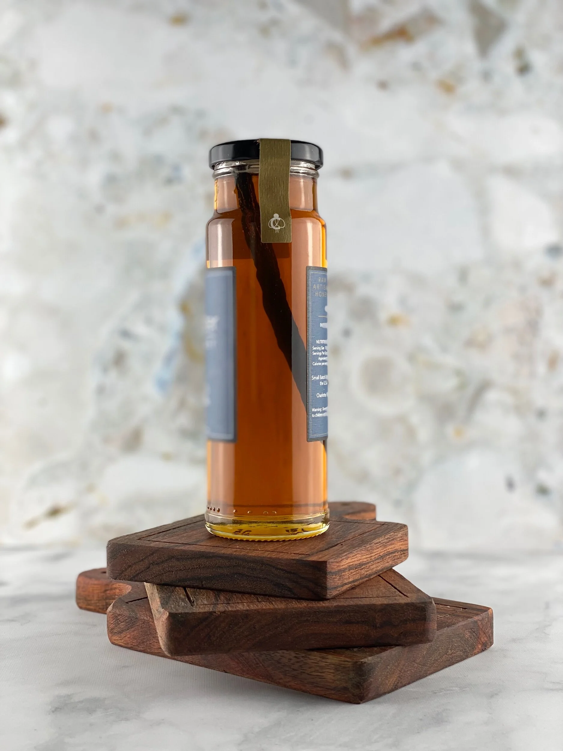 sideview of vanilla infused honey bottle