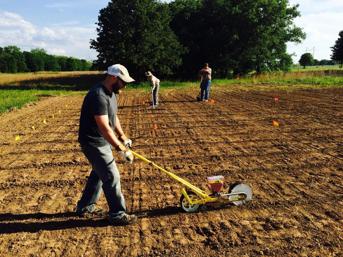 Adam Cobb tills soil to establish an experiment.