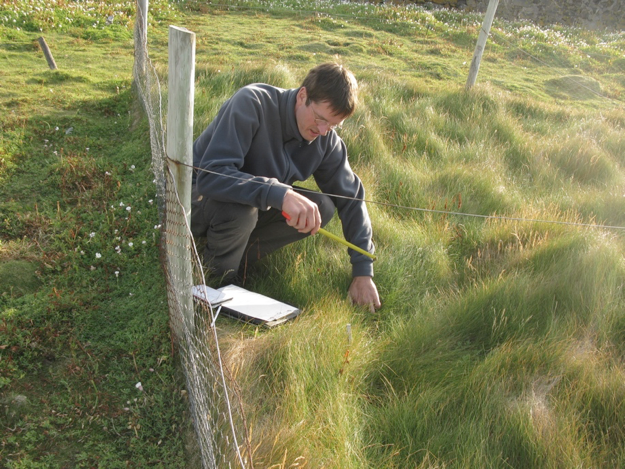 Rene van der Wal, ecologist at University of Aberdeen, surveys the plant community on Isle of May. Photo by: Walter Andriuzzi