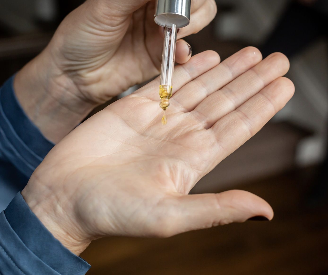 leanne delap shot drop of oil into hand pipette.png