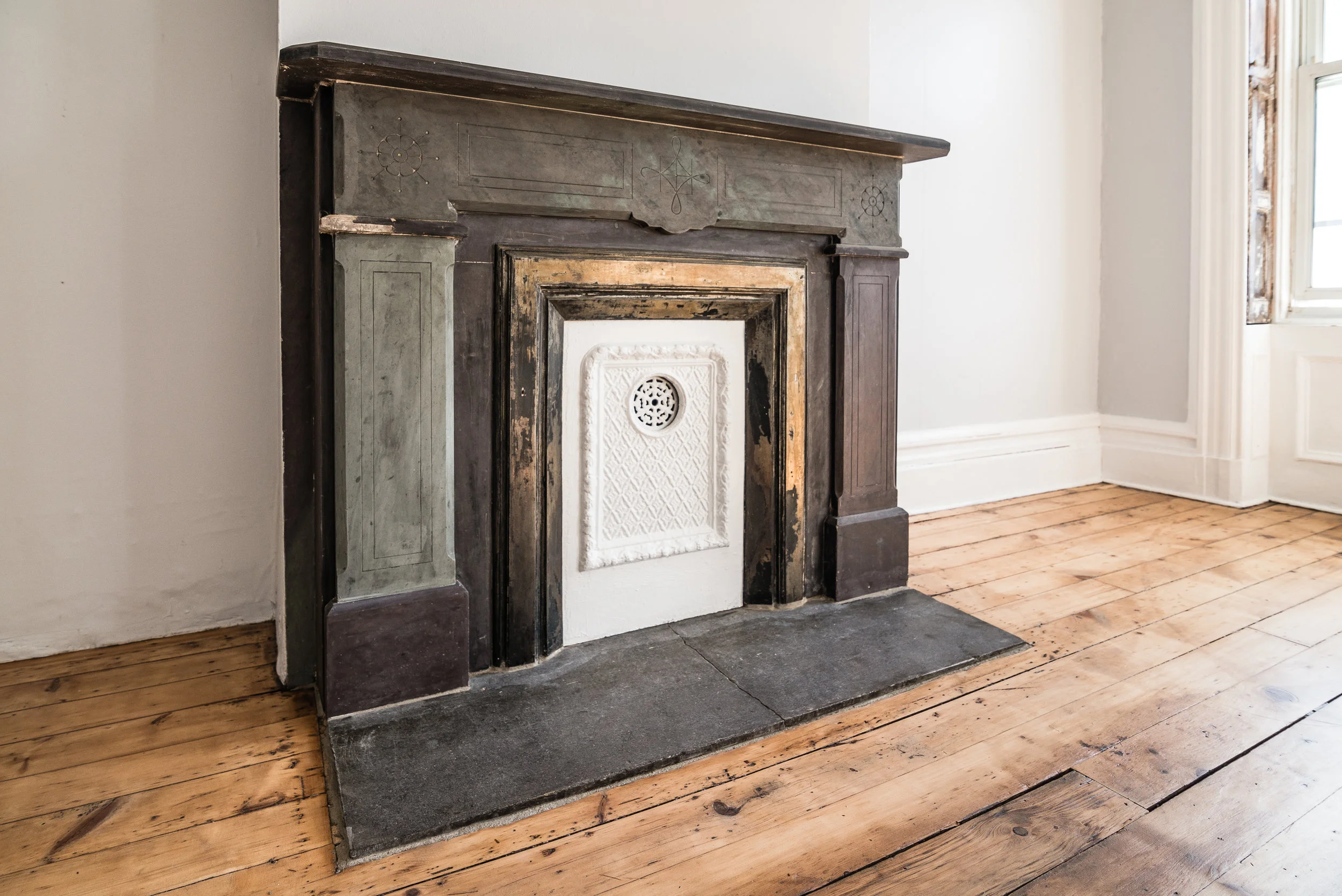 Original fireplace and gorgeous wide plank wood flooring, Jersey City Heights.