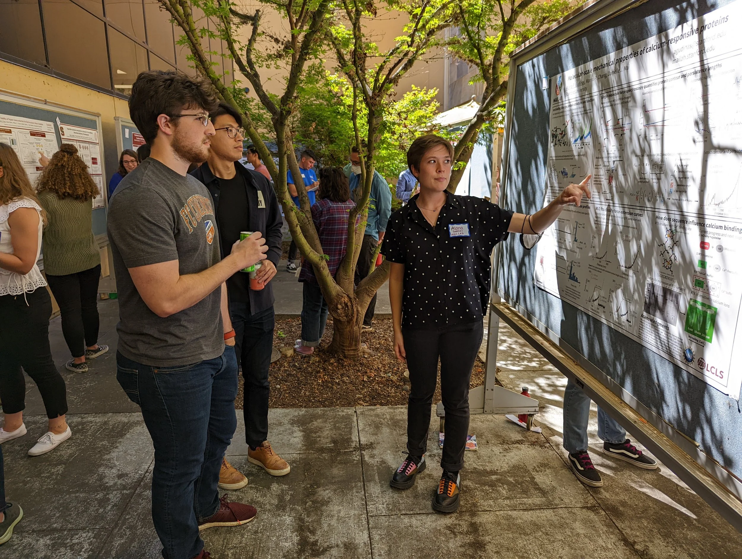 Alana shares a poster of her research to other SPC members