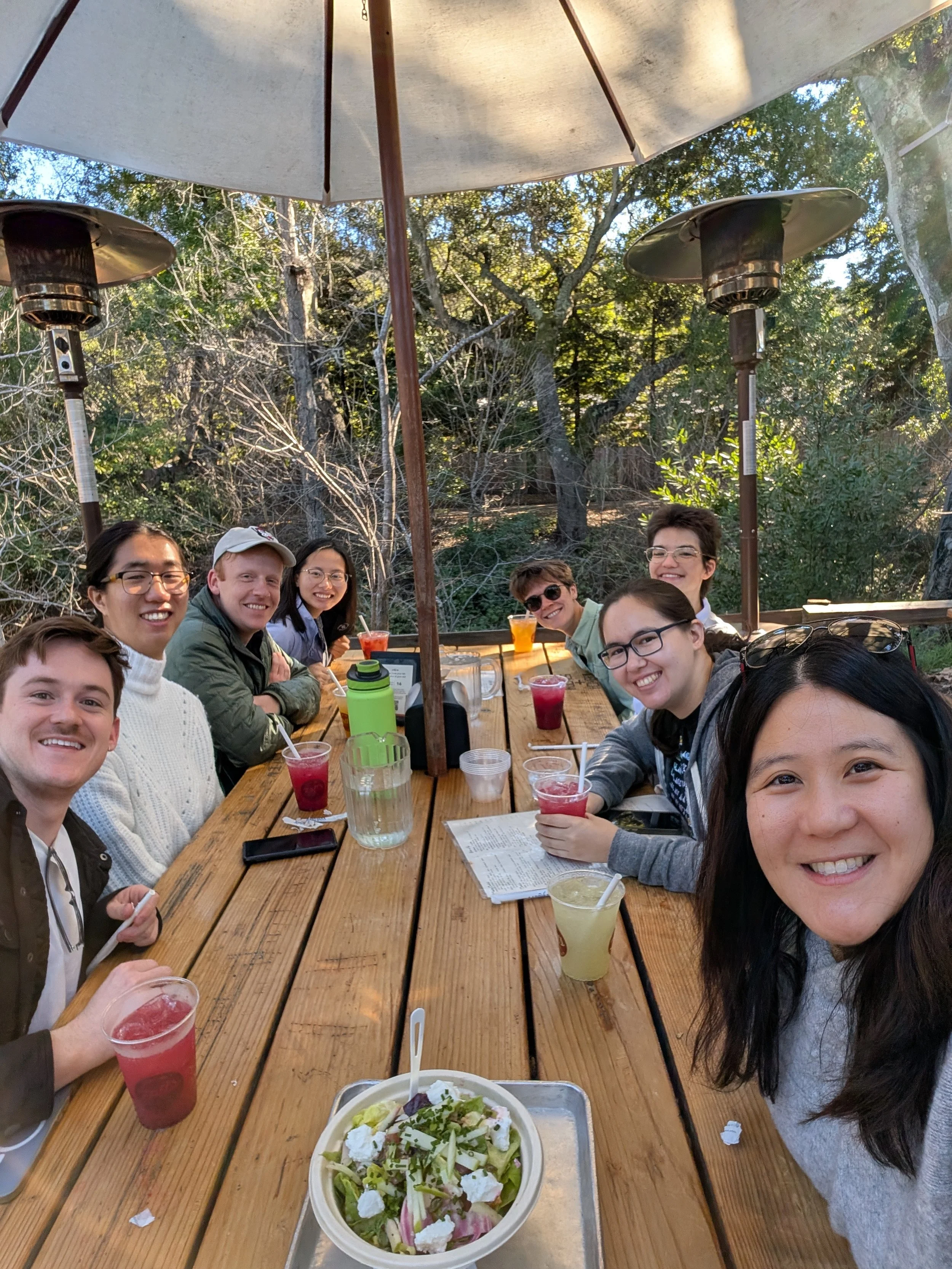 lab members sitting at a picnic table outdoors