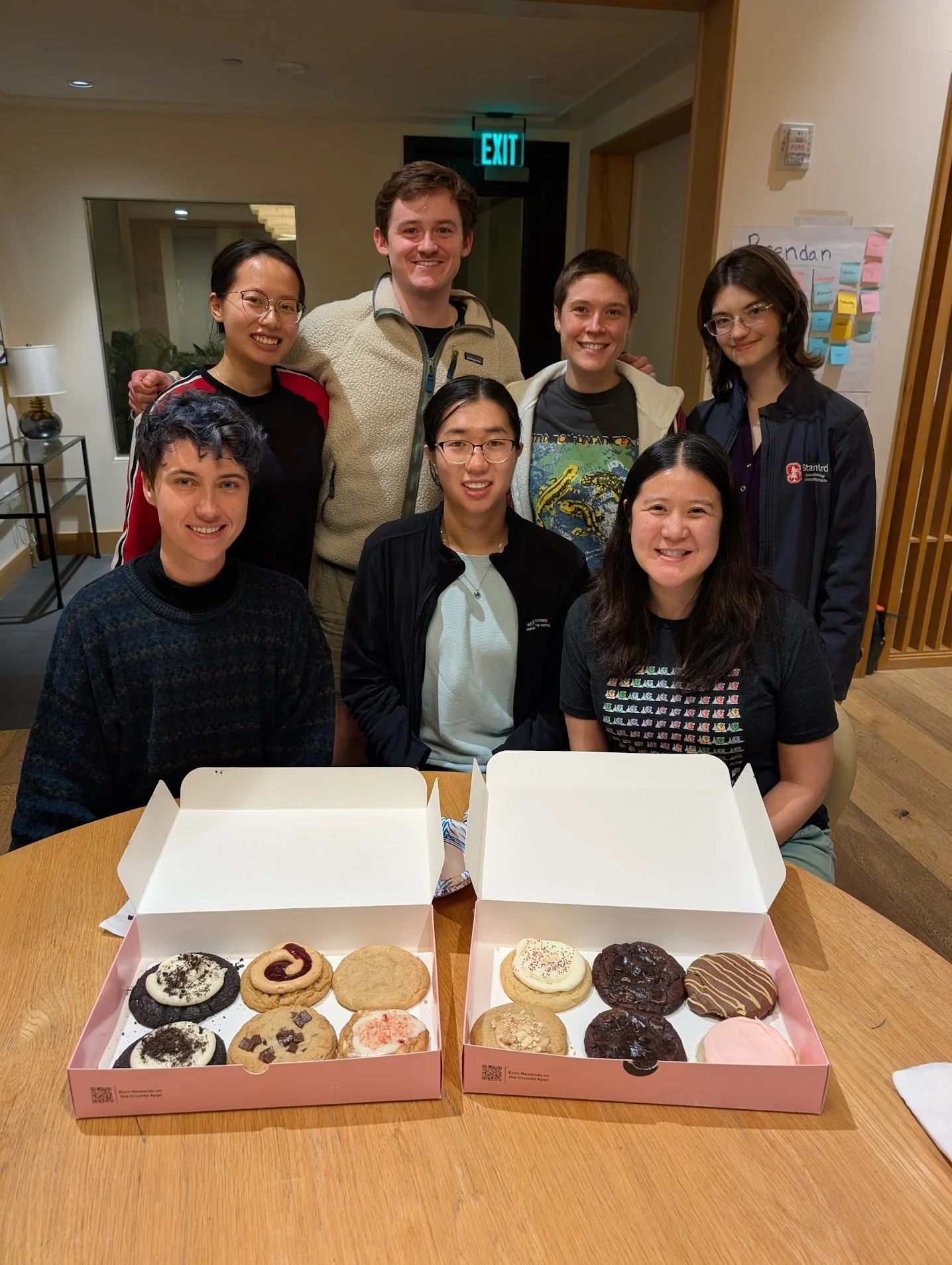 group photo, enjoying cookies from crumbl after a day-long retreat
