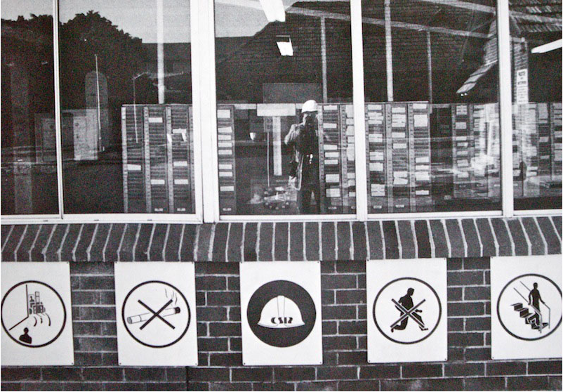 Self-portrait in front of clocking-in office, Lewis Morley