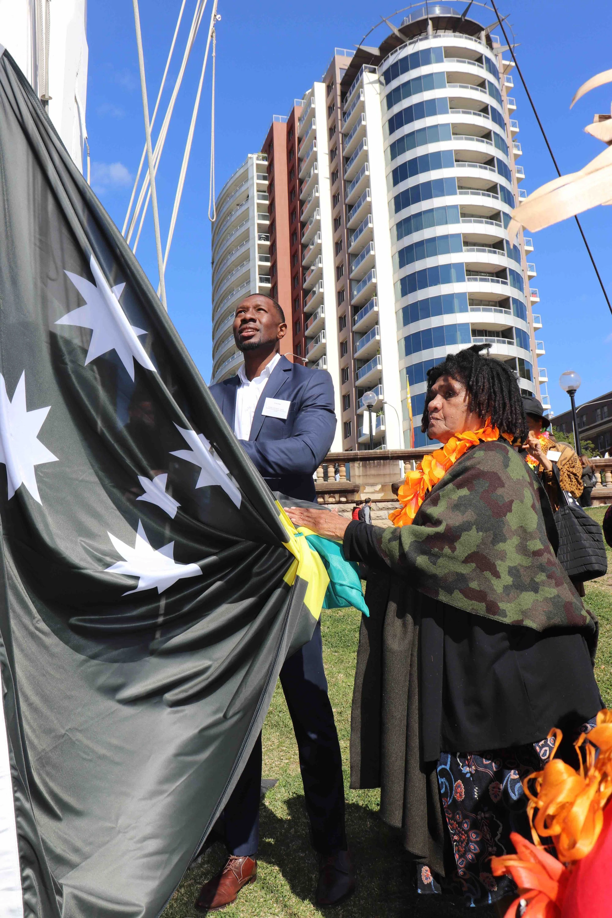 2nd and 3rd Blackbirded generation raise the Australian South Sea Islander flag. Founding members Mr. Shola Diop and Aunty Shireen Malamoo (83yrs strong)