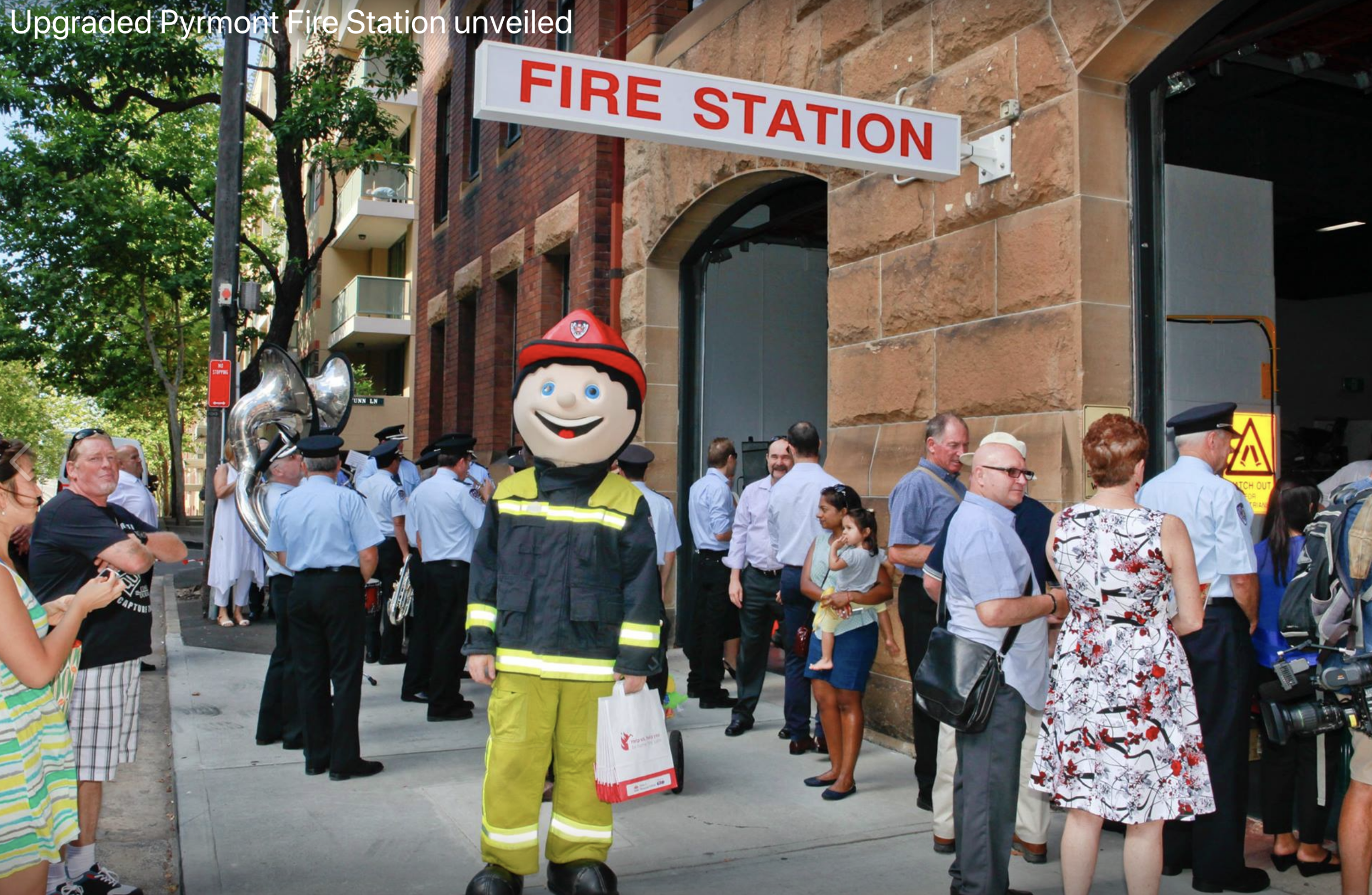 Locals and the FRNSW mascot waiting for the unveiling