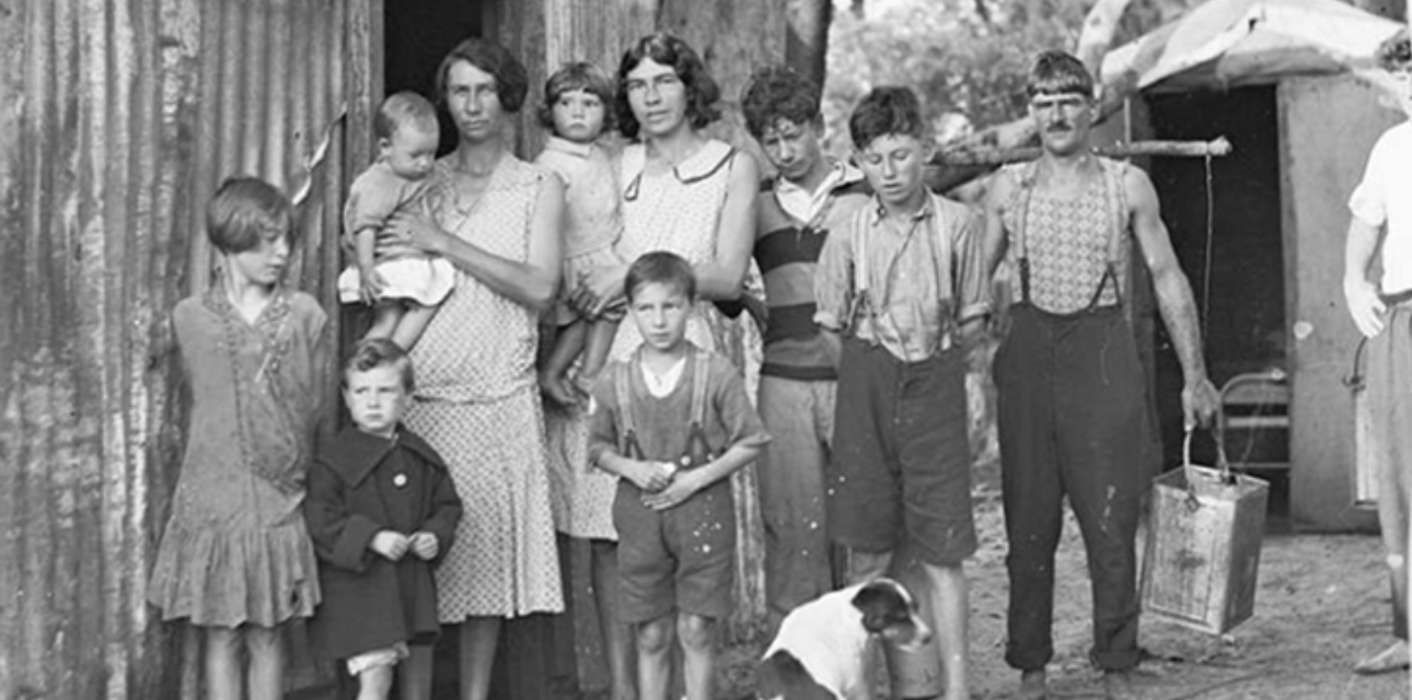 Family outside a tin shack in the Great Depression 1932