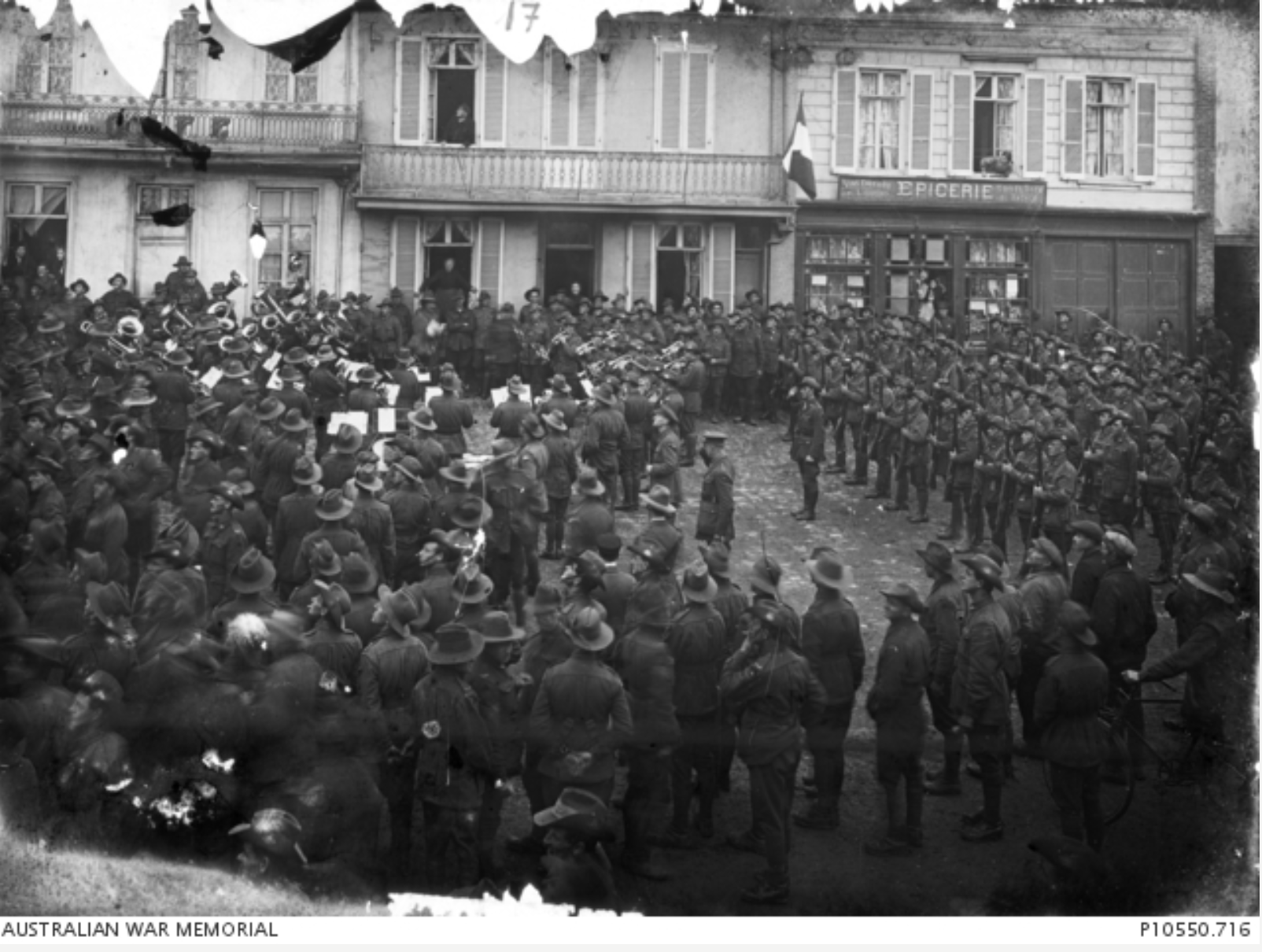 18th Battalion band plays in the Vignacourt town square as Australian troops and local townspeople celebrate the end of the war on armistice day, 11 November 1918